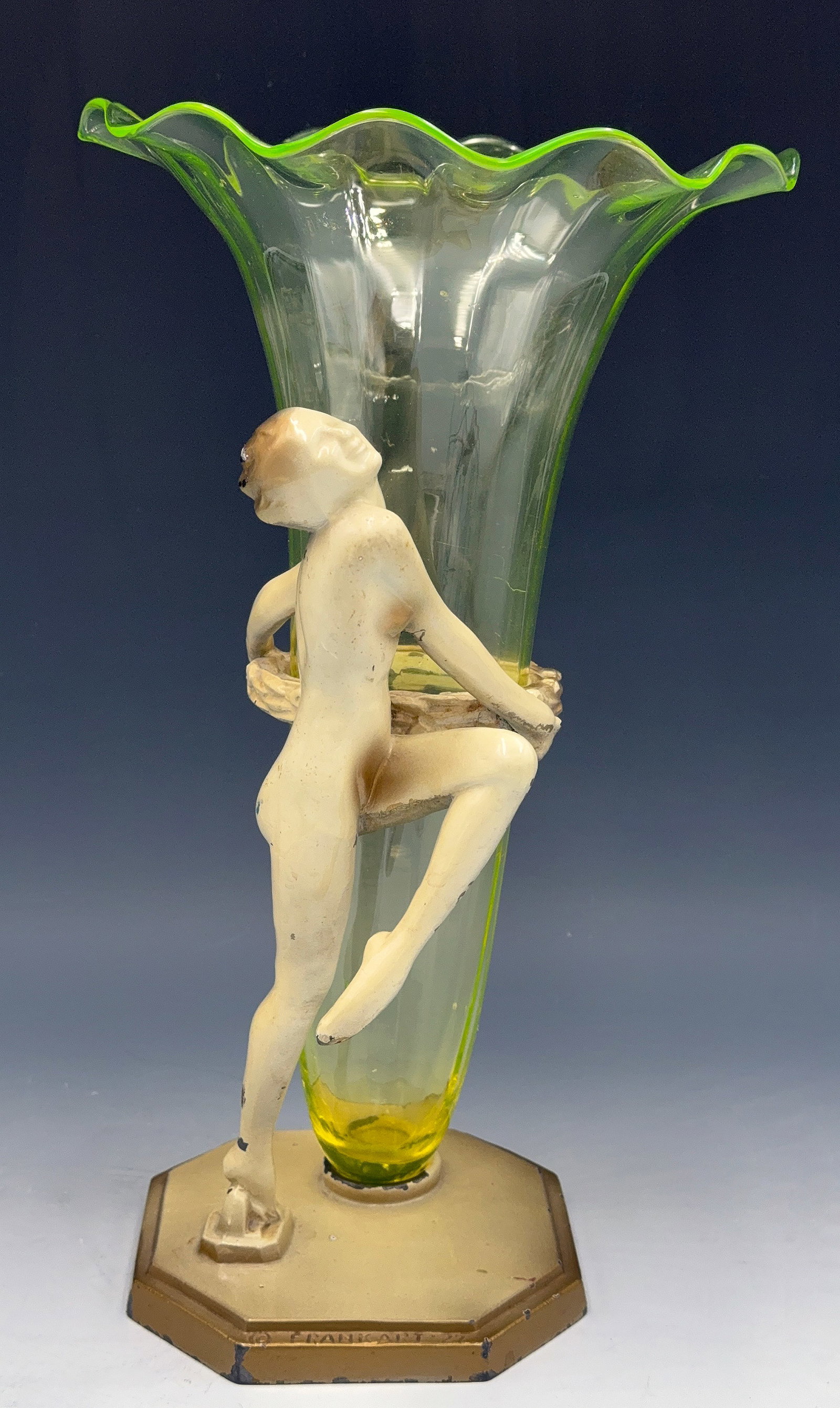 Steuben? Uranium Glass Vase w/ Frankart Nude Base.: The glass vase has a ruffled rim, and appears to be unsigned. It is not attached to the base. The painted spelter base is signed, "Frankart '27" and has an Art Deco nude holding a wreath. There is som