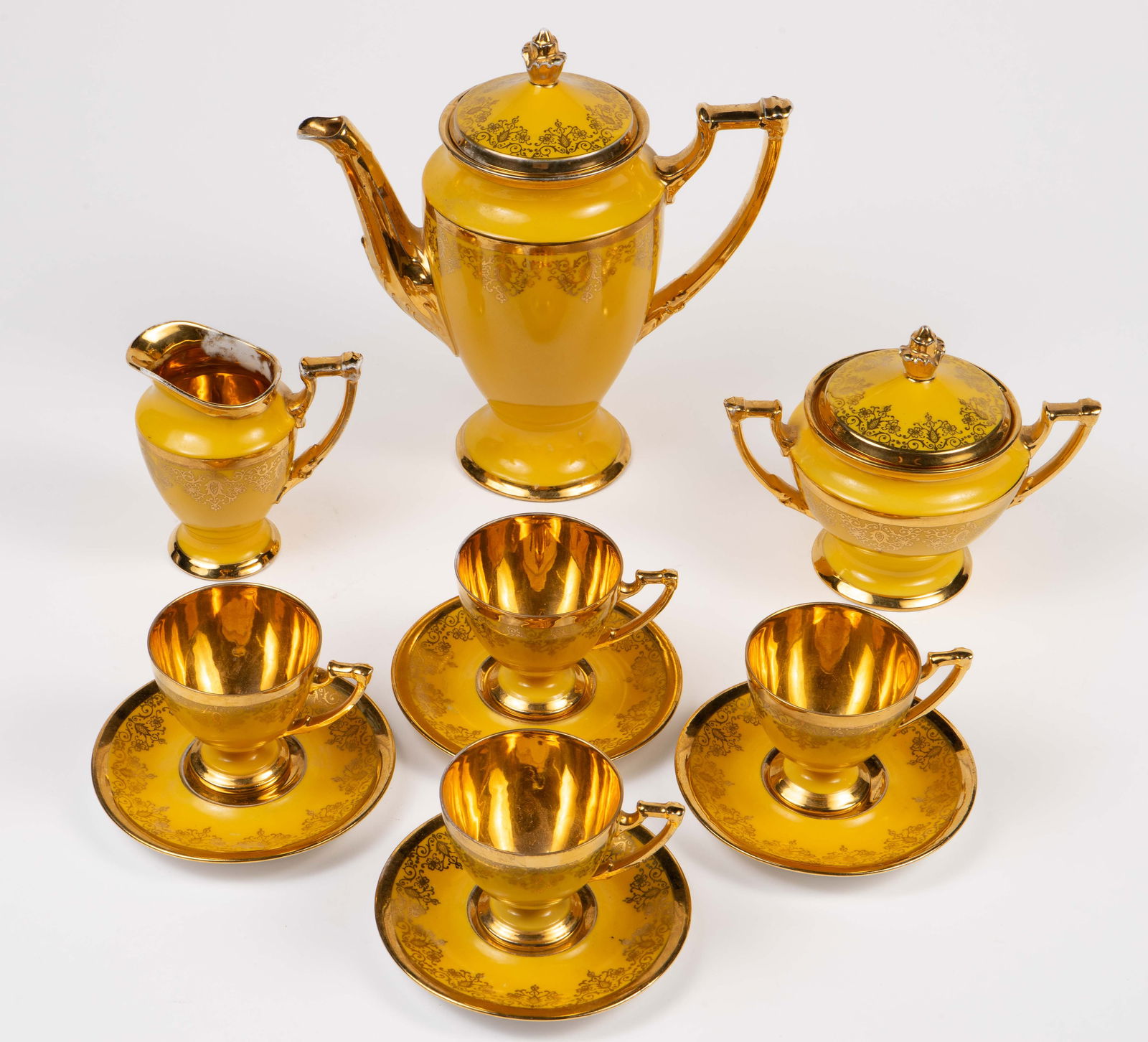 Royal Epiag 24K Gold Decorated Coffee or Tea Set.: The pieces are stamped, "Hand Decorated 24 Karat Gold". The set consists of the following: 4 demitasse cups, 4 saucers, a coffee pot w/ lid, a sugar bowl w/ lid, and a creamer. There are some areas wi