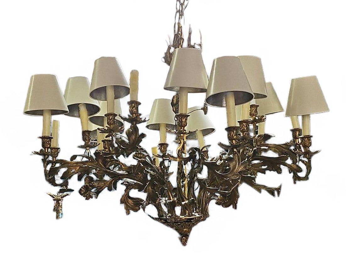 Antique 18-Arm French Bronze Chandelier.: This bronze chandelier has 18 arms, which hold faux candle lights which have white shades. The fixture is very heavy, and seems to lean to one side when hung (it probably needs adjusting). It features