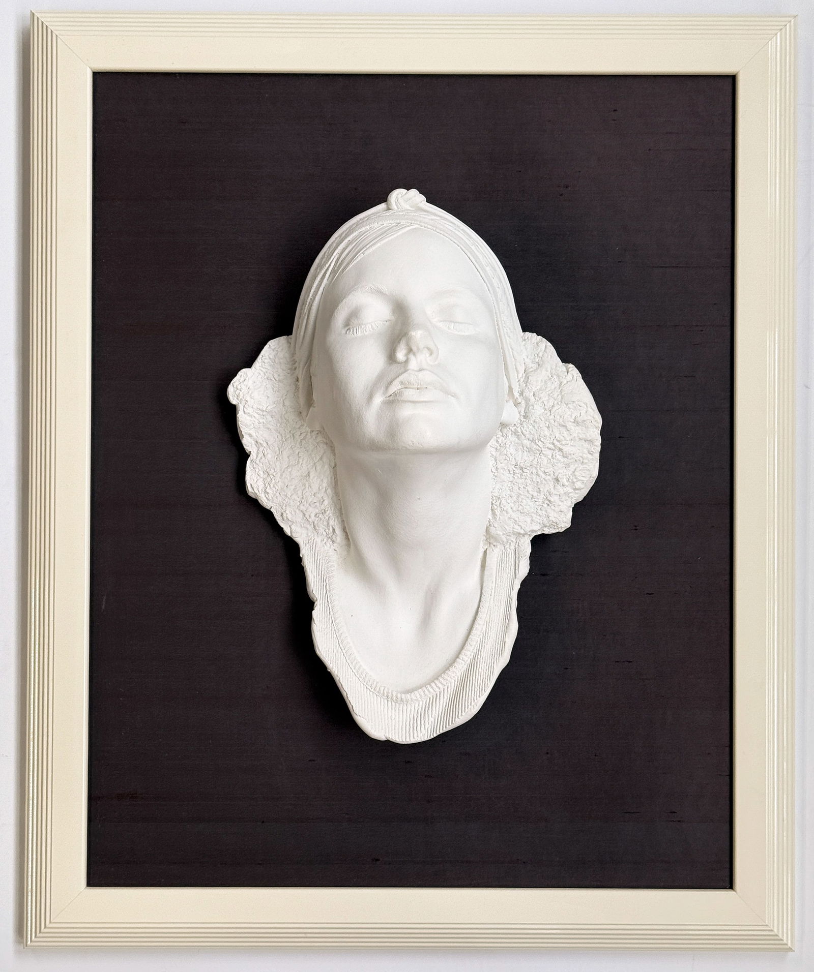 Marc Sijan White Matte Female Head In Frame.: It is attached to a brown board, and housed in a white frame. Overall, the piece looks to be in good condition. Its dimensions are 27 7/8" x 22 3/4" x 7 1/4". In-house shipping is available. Please se