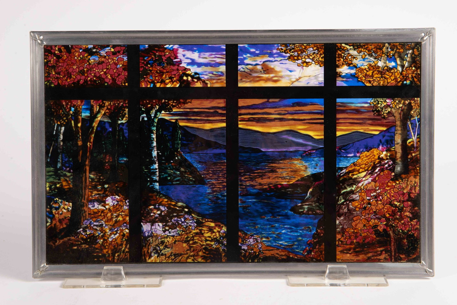 "Tiffany Sunset" Repro Stained Glass Suncatcher.: This small window is made by Glassmasters, after a Louis Comfort Tiffany creation. Aside from some minor dust, it looks to be in good condition. It comes with a hanging chain and plastic easel support