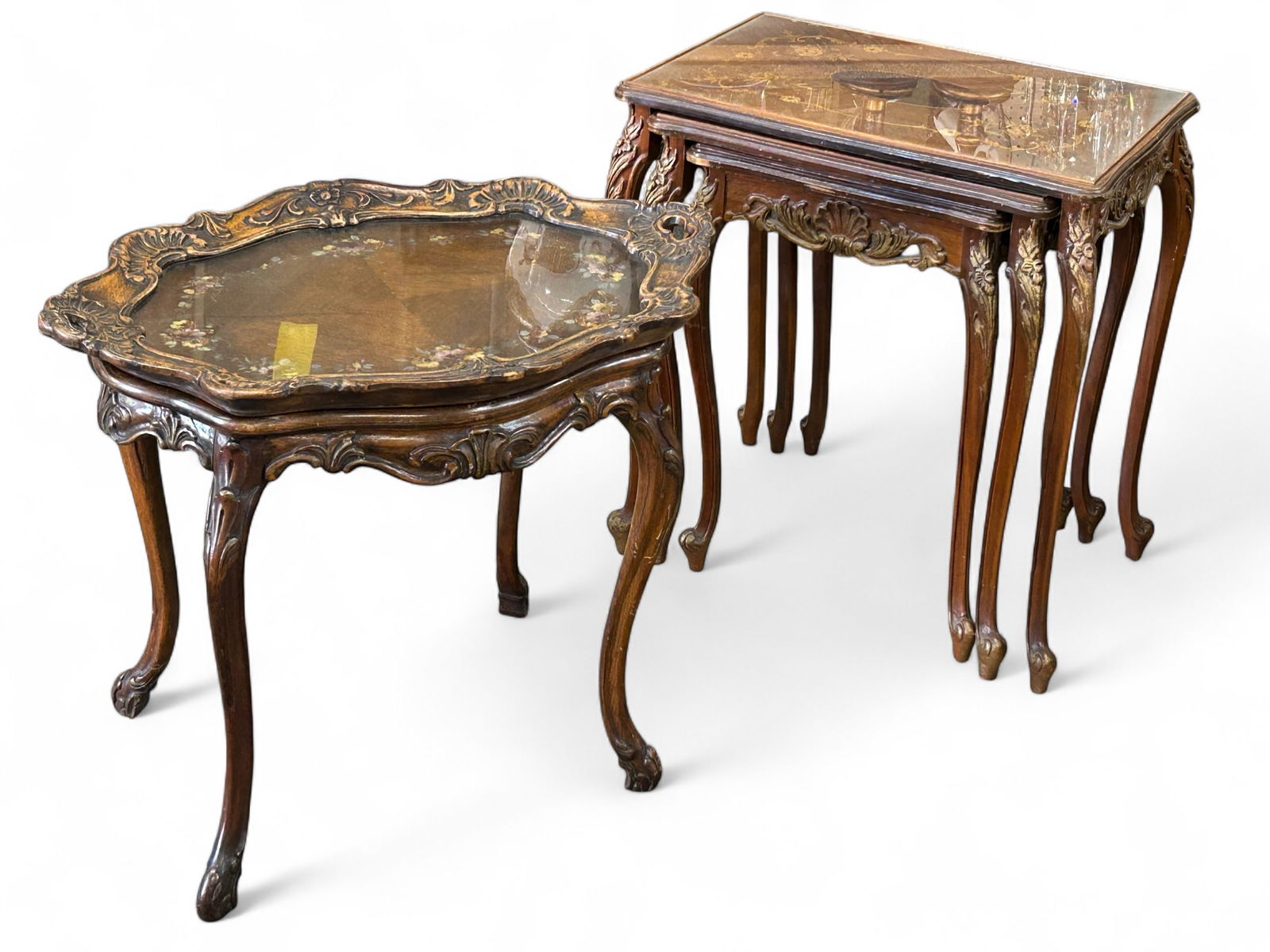 Lot: Carved Antique Tray Table & Nesting Tables.: The first part of the lot is a 3 table nesting piece with carved and gilded flower and fan decorations, lyre legs, paw feet and marquetry tops. The two largest tables also have protective glass tops.