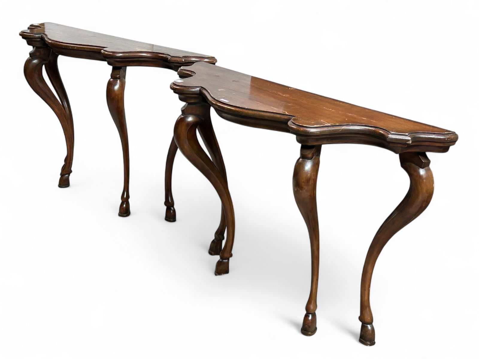 Pair of Italian Console Tables.: These tall dark wood tables each sit on four cabriole legs with hooved feet. They are free standing, but are meant to stand against a wall. Both are in rough shape, with lots of scratches and surface