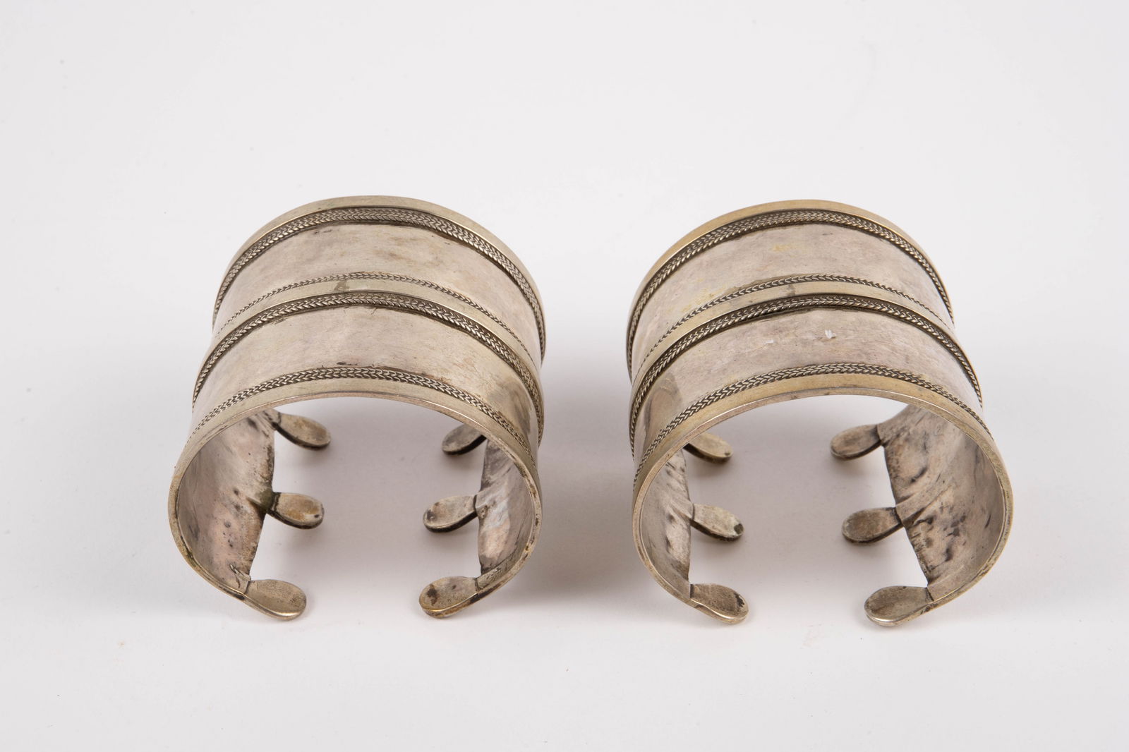 Pair of Solid Silver Turkman ? Cuff Bracelets.: The lot contains 2 sterling silver cuff bracelets, which may have once been gilded. Each piece measures 2 1/2" across the inside, and 2 5/8" wide. The lot weighs 5.05 Oz. Troy, or 157.2 Grams. There a