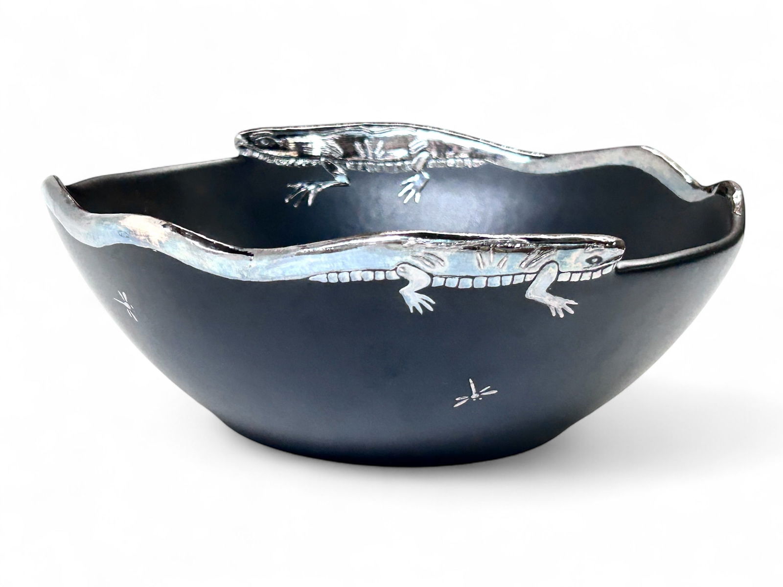 Emilia Castillo Porcelain & Silver Bowl, 2009.: The bowl is matte black with silver painted designs of lizards and fireflies. It is signed Emilia Castillo / Plata / Mexico / 09 on the underside. It measures 3 1/2" x 9 1/4" x 9 1/8". It is in overal