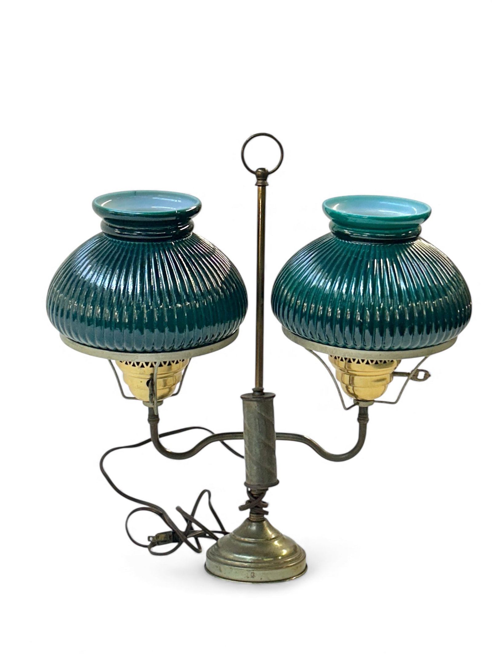 Brass Double Student Lamp w/ Deep Teal Shades.: The electrified lamp has a brass frame and 2 ribbed chimney shades. The body measures 18 1/2" x 16 1/2" x 7 1/2". The brass has scratches and stains, and there are some flea bite chips on the edges of
