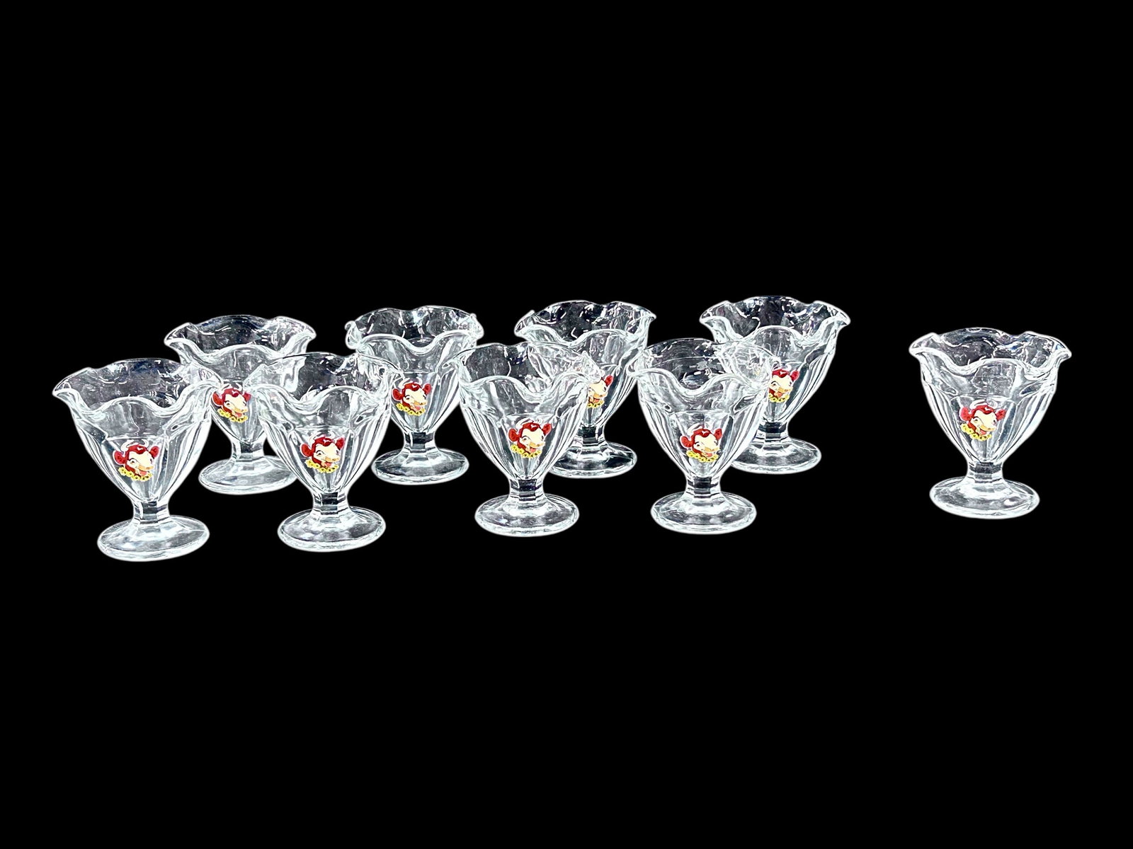 9 Borden Food Elsie the Cow Ice Cream Cups.: The vintage promotional cups feature a portrait of Elsie the Cow with a flower necklace. Each footed ruffled dish measures 4" x 3 3/4". The cups are in overall very good condition. In-house shipping i