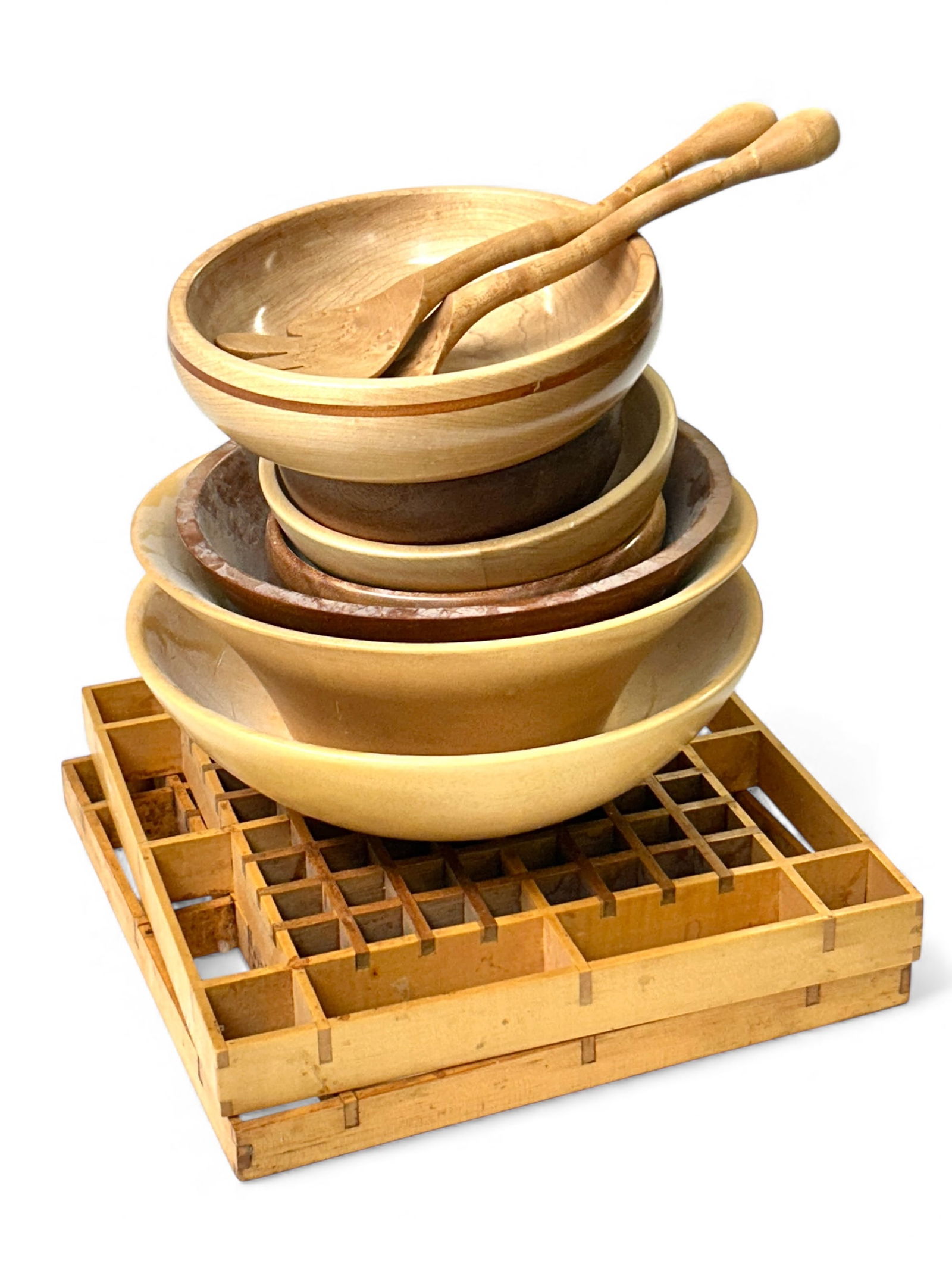 Lot of Wooden Kitchen Items - Bowls, Trivets, Etc.: The lot contains 11 items. There are 7 turned wood bowls, include one signed JRW. Next, there are two wooden grid tivets. And finally, there is a pair of salad servers which are signed PD or RD. The s