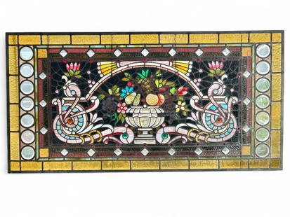 Antique Stained, Bevelled & Jewelled Glass Window.: This old leaded glass window depicts a basket of fruit, a flower, scroll, and geometric decorations. The glass is textured, bevelled, and multifaceted. It measures 24 1/2" x 48". One of the round