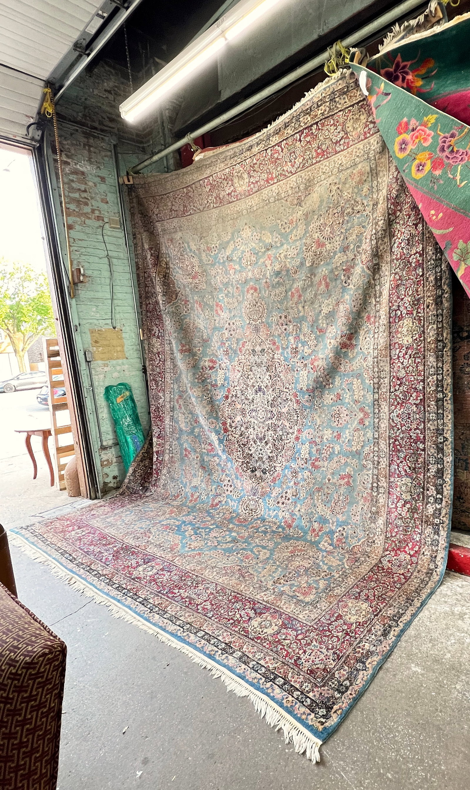11' 9" x 15' Palace Size Kirman Rug.: The rug has wear in several areas, but is quite ornate. It could use a good cleaning. Otherwise, it looks to be in reasonably good overall condition. In-house shipping is available for this rug. Pleas