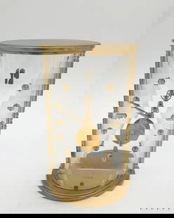 LeCoultre Brass & Lucite Mystery Clock: The vintage 8 day clock is marked LeCoultre / 16 Jewels / Unadjusted on the movement, and LeCoultre / Swiss / 348 on the underside. The clock has a brass body, bevelled triangular frosted Lucite side