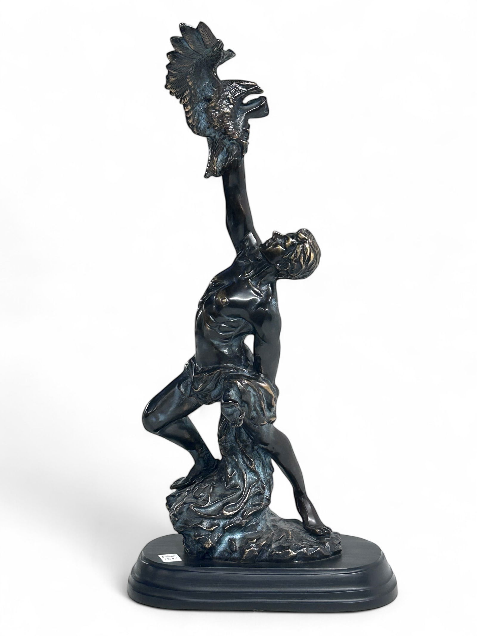 Classical Bronze Sculpture of Figure w/ Eagle.: The patinated bronze statue depicts a draped male figure with an eagle on his arm above his head. It measures 23 3/4" x 11 1/2" x 11", including the black metal base. There are a few scratches on the