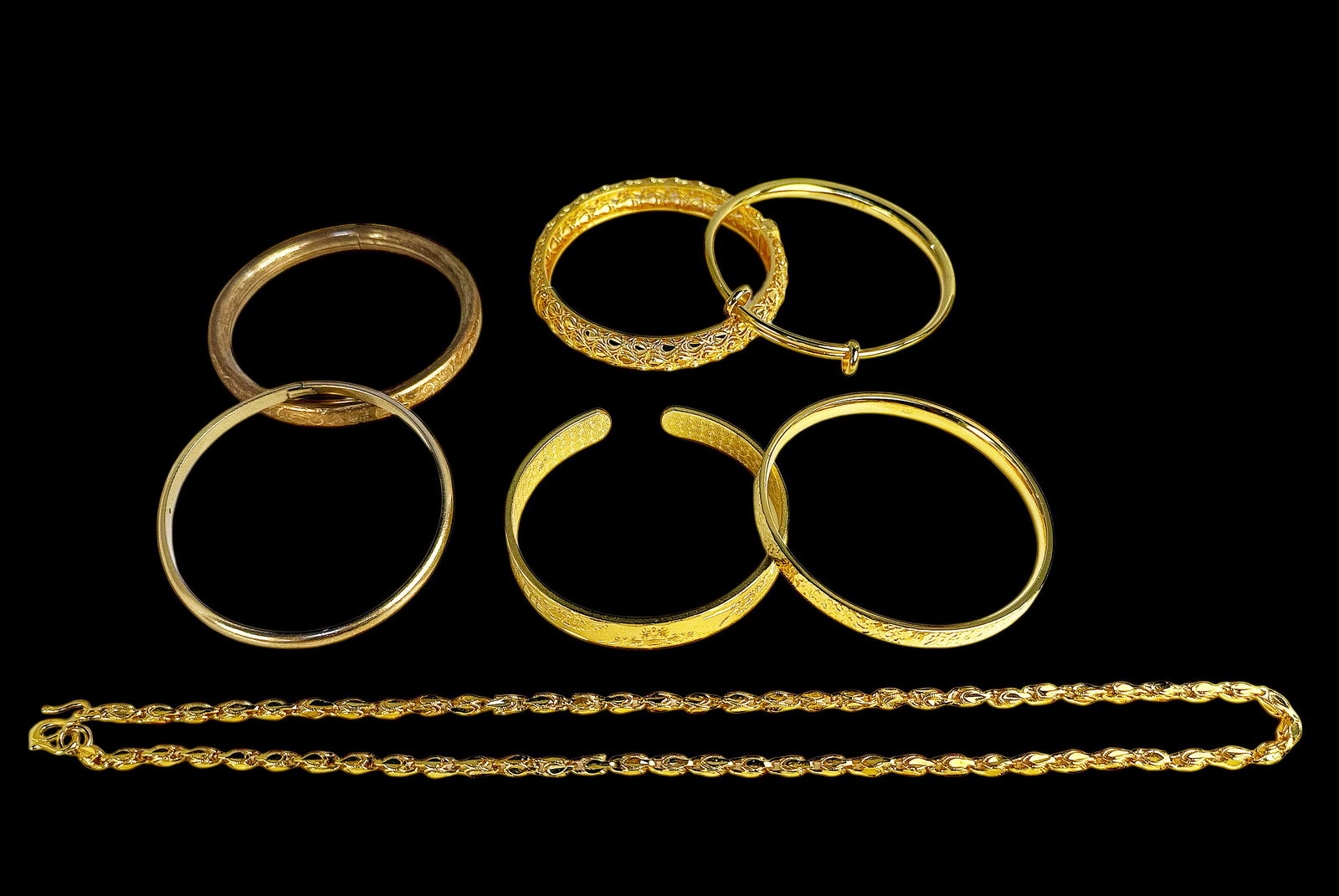 Lot of Gold Plated or Filled Jewelry & Bangles.: The lot contains 7 items - 6 bangle bracelets, and one necklace chain. One of the bracelets is marked Windard 1/20 12K GF. The bracelets measure roughly 2 5/8" in diameter, and the chain measures 20"