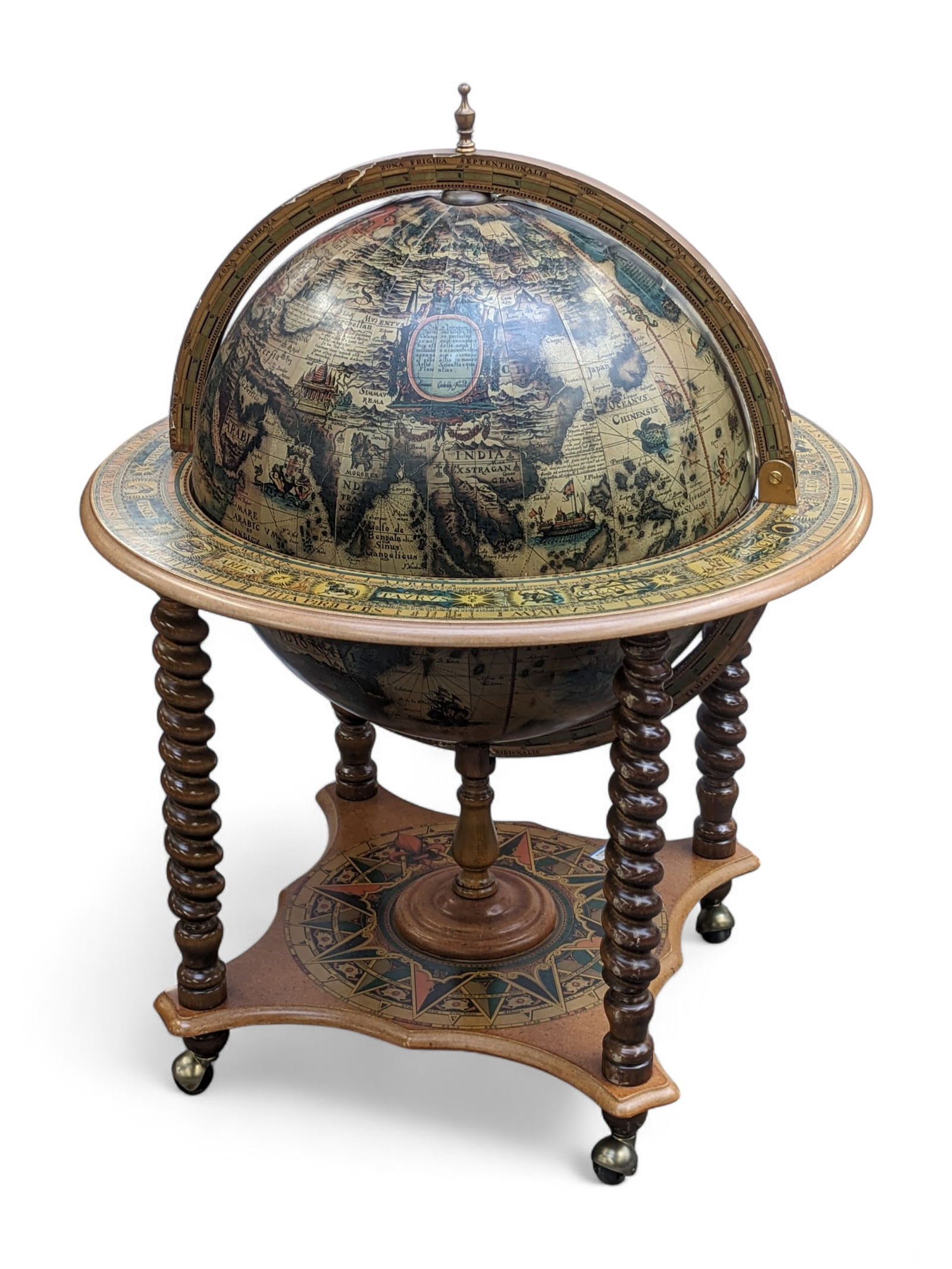 Vintage Zodiac Terrestrial Globe Bar Cart.: The upper half of the globe lifts up to reveal a bar, complete with an ice bucket. The globe sits on four barley twist legs connected to a lower shelf, that sits on four wheels. It is made of pressed