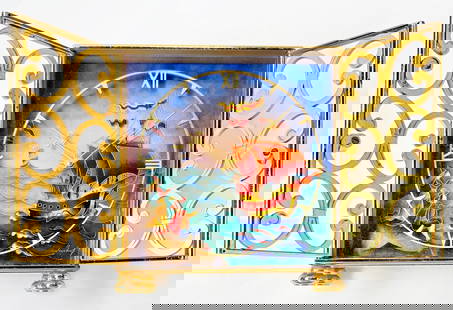 Imhof Gilded Enamel Clock, Maritime Scene: This mid century table clock has a gilded metal case with two pierced doors, and an enameled face with a polychrome maritime scene with gild details. The scene depicts sailing ships and a couple of