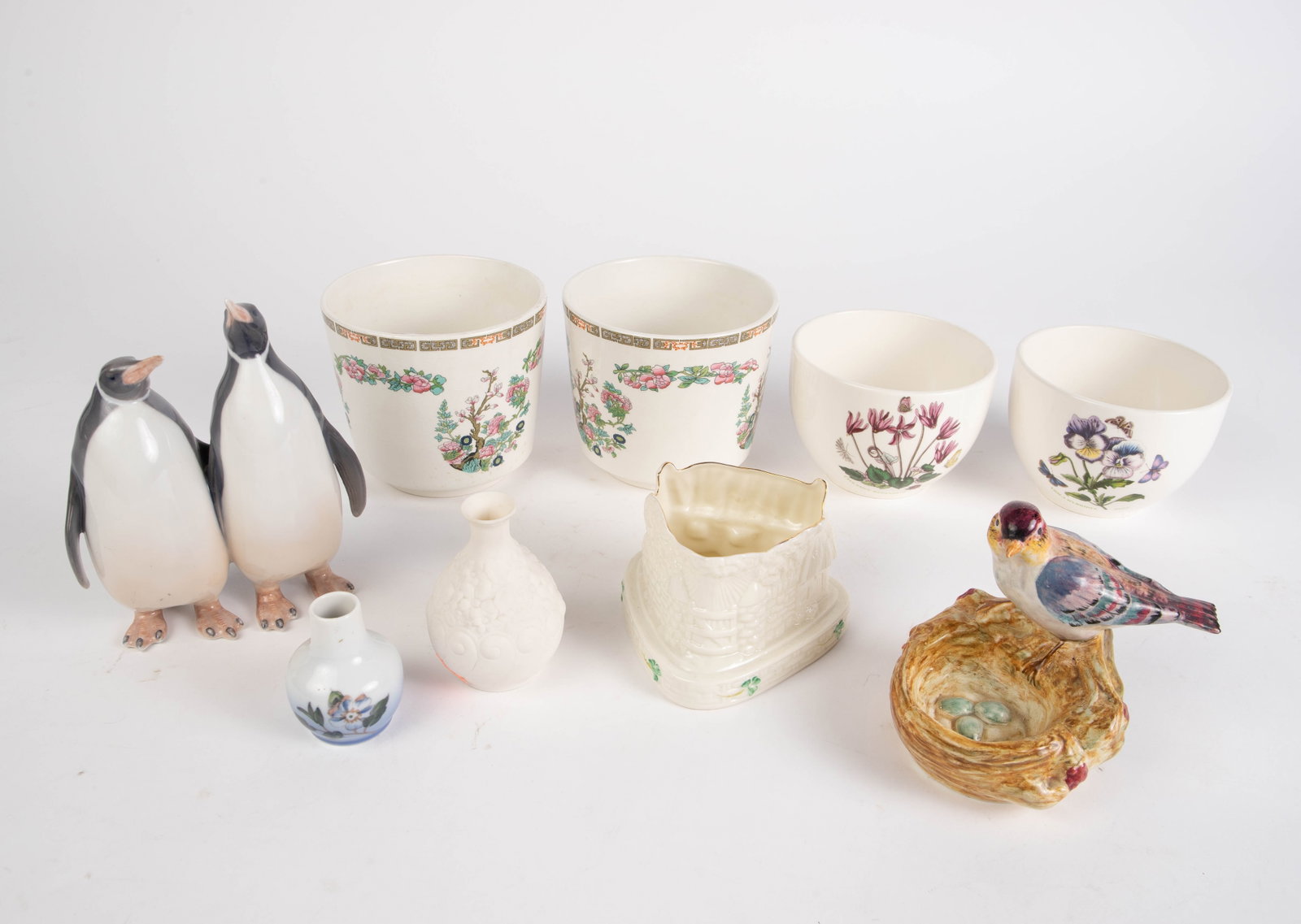 Lot: Royal Copenhagen, Wedgwood, Boehm, etc.: This lot includes figurines, vases, and bowls. The makers include Royal Copenhagen, Enoch Wedgwood, Portmeirion, Boehm, Belleek, and more. Overall, the lot looks to be in good condition, with some cra