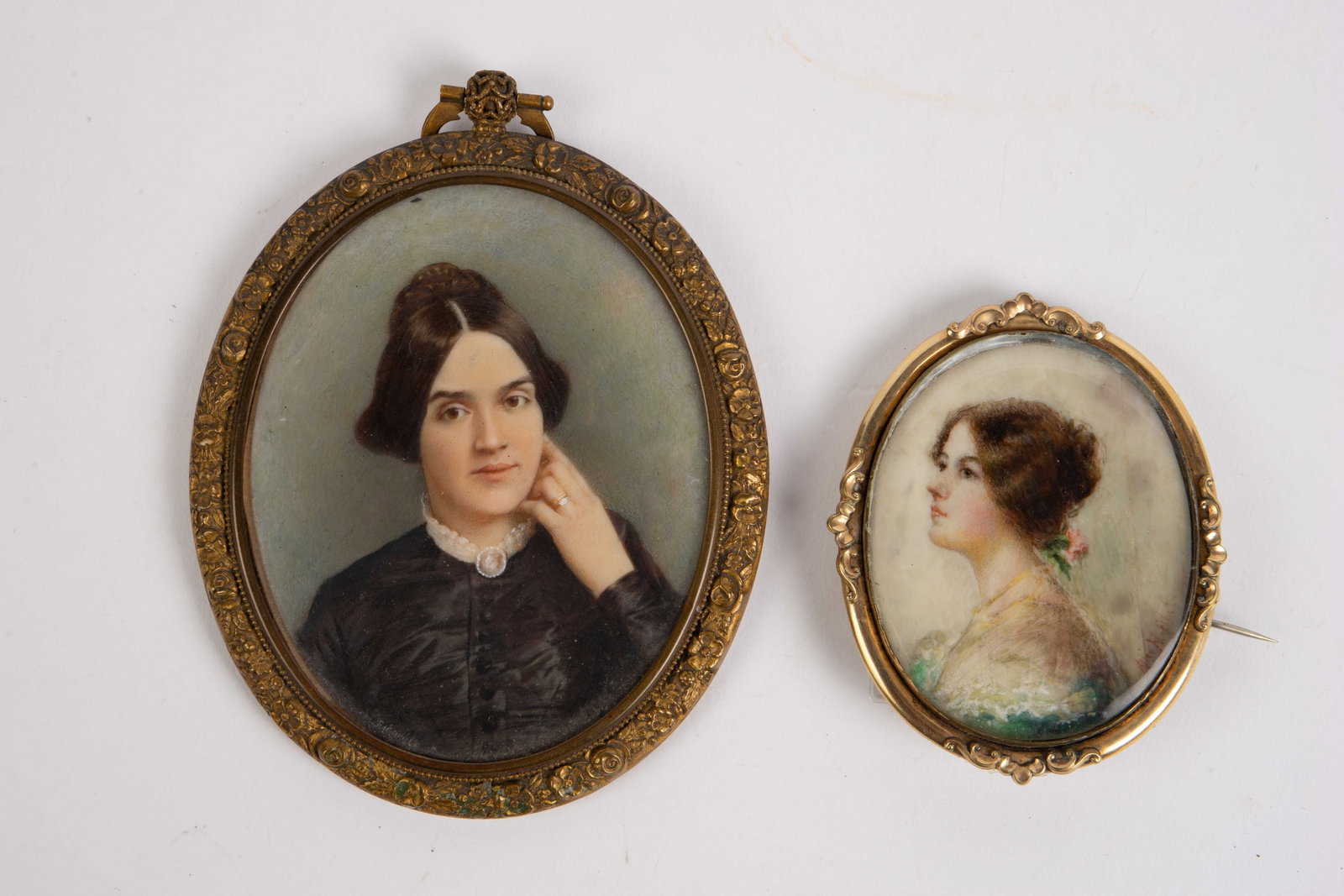 Lot of 2 Miniature Painted Portraits of Ladies.: The larger portrait appears to be signed, "A.L. Eikardt". The smaller one is signed, "Alice M. Flint" (for Alice Morland Flint). The glass in this smaller portrait is intact, but uneven in the frame. 