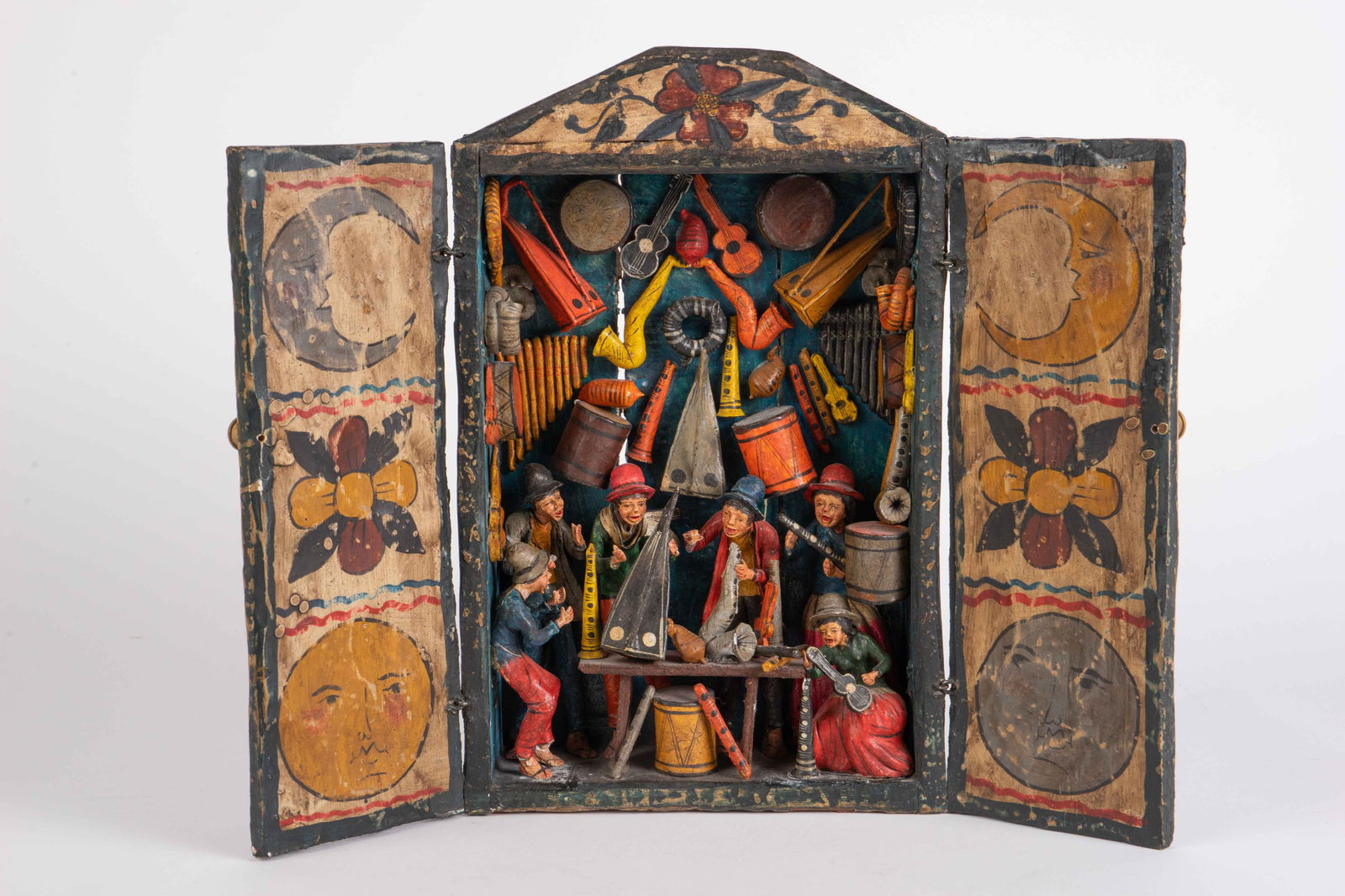 Nicario Jimenez Folk Art Retablo of Musicians.: It is signed on the back. This hand painted retablo box displays a group of musicians surrounded by a variety of musical instruments. It looks to be in overall good condition. When closed, it measures