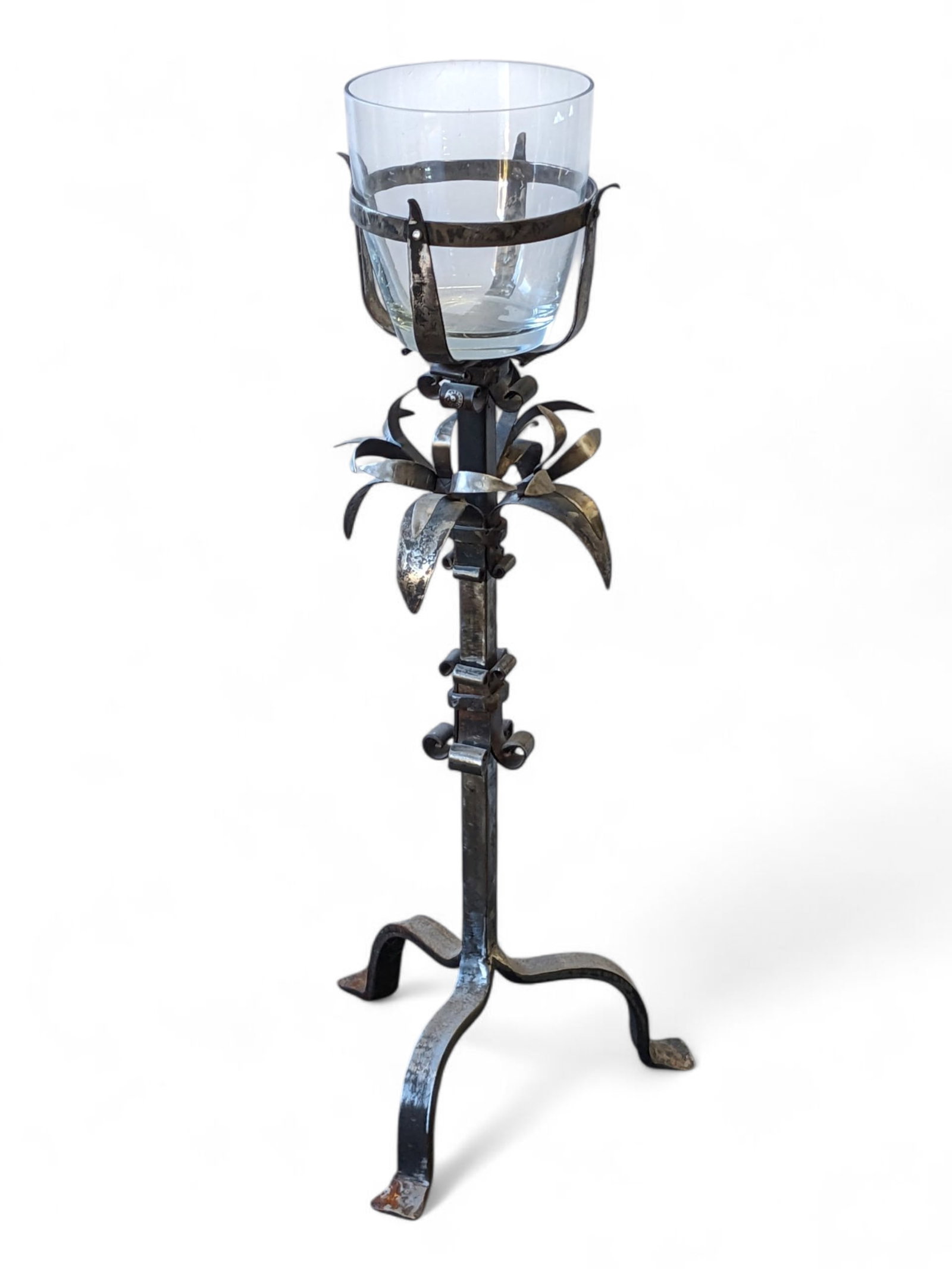 Wrought Metal Plant Stand with Glass Bowl.: This wrought stand has a floral design and carved details. The piece is in nice condition, with only a few light scratches. The bowl has a 7 1/2" diameter, and the base has a 12" diameter. It measures