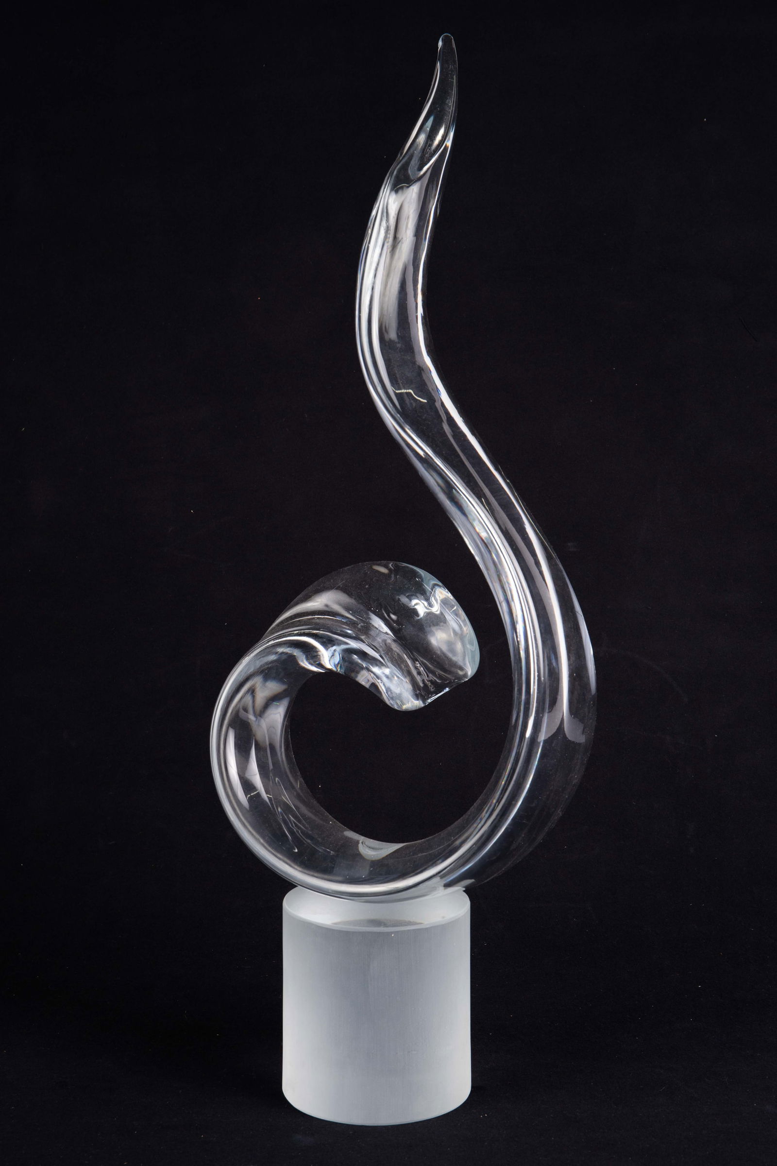 Elio Raffaeli Abstract Murano Glass Sculpture.: The large glass sculpture depicts an abstract clear glass swirl in a flame shape. The piece is titled Dante's Flame, and is signed Elio Raffaeli on the underside of the frosted glass base. The piece m
