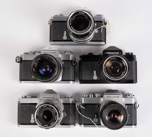Five Nikon Nikkormat Cameras with Lenses.