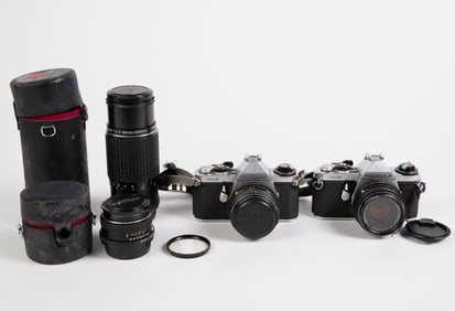 Two Pentax ME Cameras with Four Pentax Lenses.