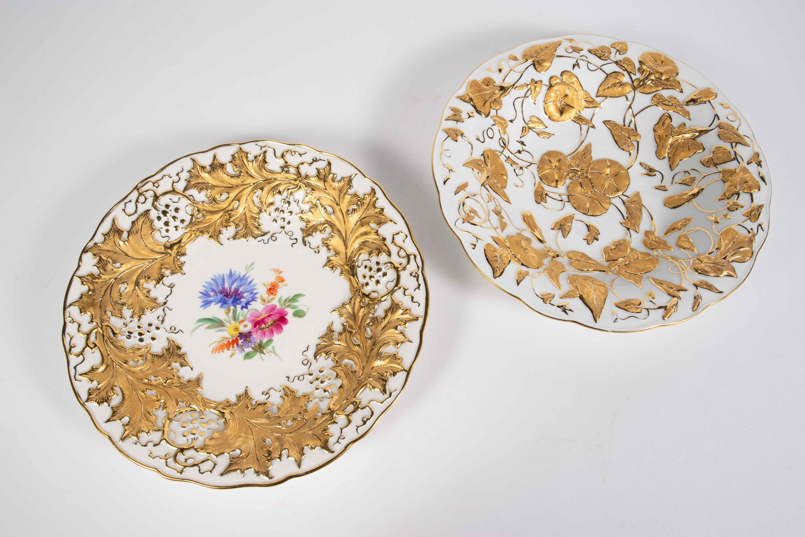 Lot of 2 Meissen Gilded Pompous Bowls.: This lot includes two different Meissen pompous bowls with ornate gold flower and leaf designs. Aside from some minor gilt loss, they both look to be in nice condition. Each bowl bears the Meissen blu