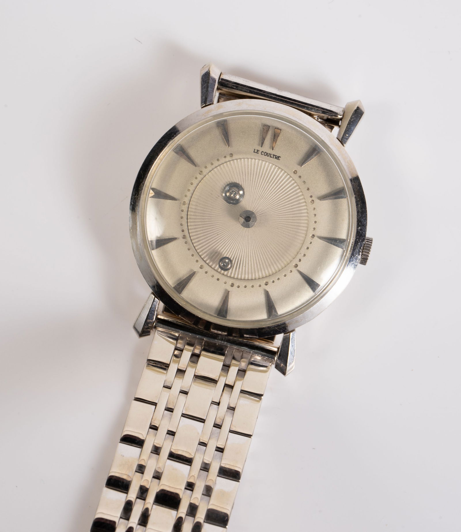 LeCoultre 14K White Gold Mystery Watch w/ 14K Band: The watch is marked K.F. / 14K on the back of the case, and 14K Longines on the band. The case measures 32mm in diameter. The watch and band weighs 42.7 Pennyweight, or 66.4 Grams (including the movem