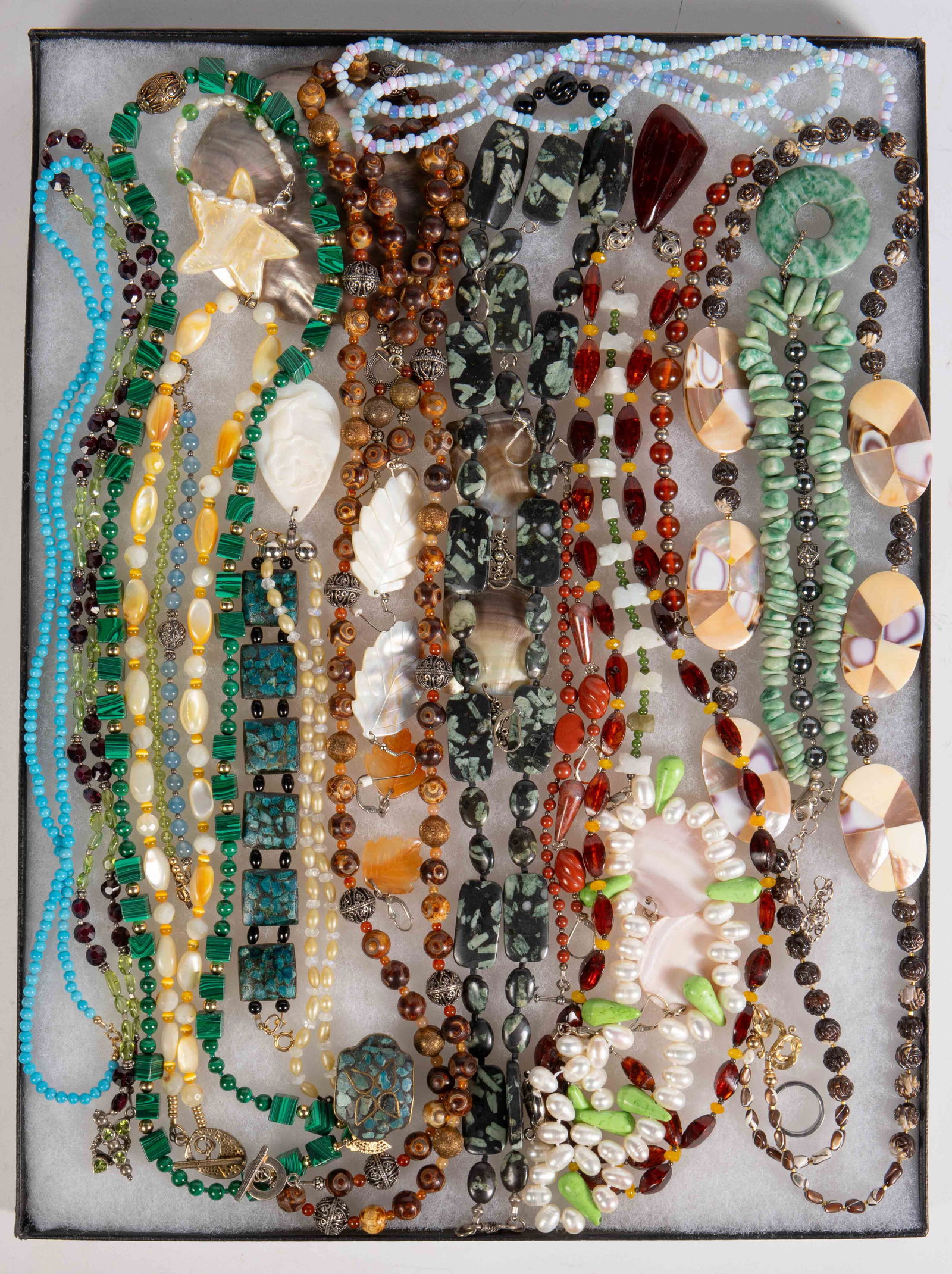 Lot of Gemstone Jewelry - 925, Malachite, Amber.: The lot contains over 30 pieces of jewelry. There are necklaces, earrings, bracelets, and a few 2 or 3 piece sets. Many of the items have sterling silver clasps and/or elements. Some of the stand out