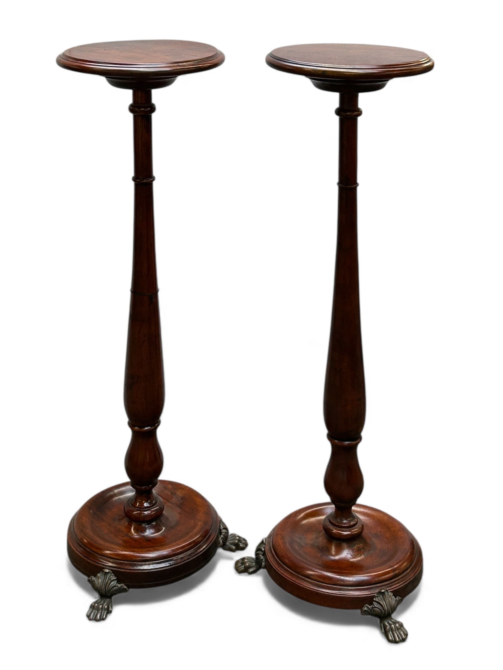 Pair of Mahogany Pedestals w/ Paw Feet.: One of the stands has a Theodore and Alexander quality passed sticker on the underside. The turned wood fern stands each have three bronze paw feet. The stands each measure 42" x 15" x 15". There are