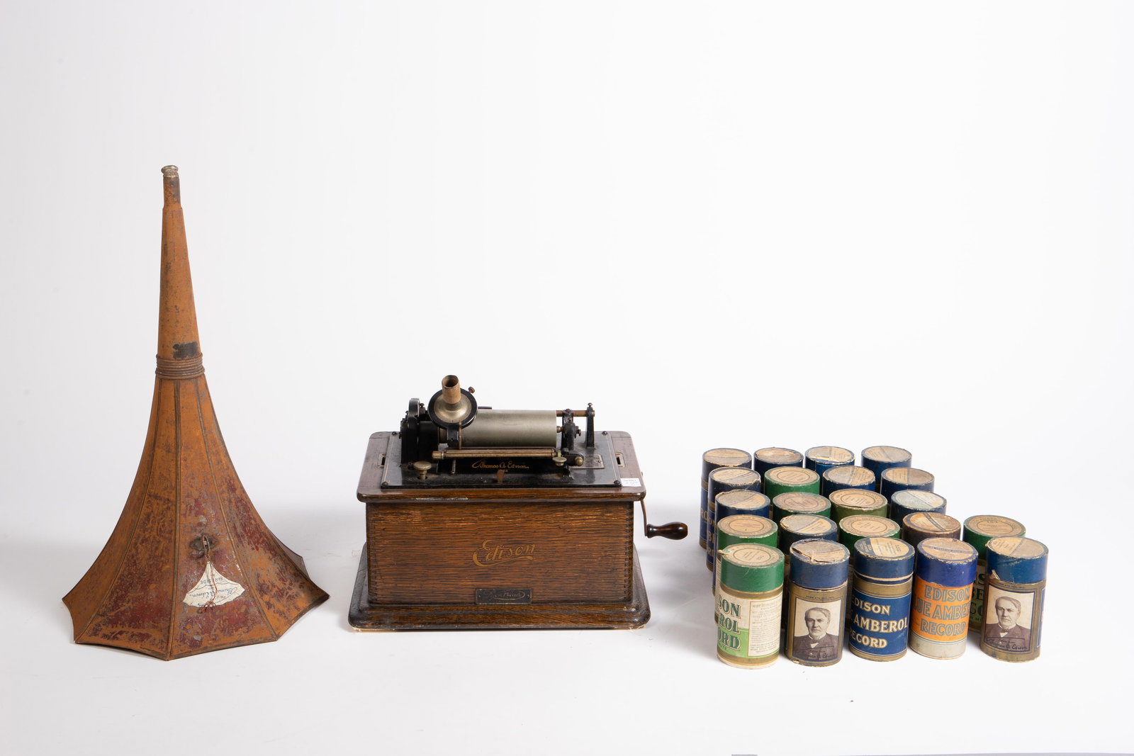 Lyon & Healy Edison Cylinder Phonograph.: The phonograph has its crank, and comes with several cylinder records. The flywheel and mechanism underneath spins, but there is no rubber drive belt. There is also no needle to test it with. There ar