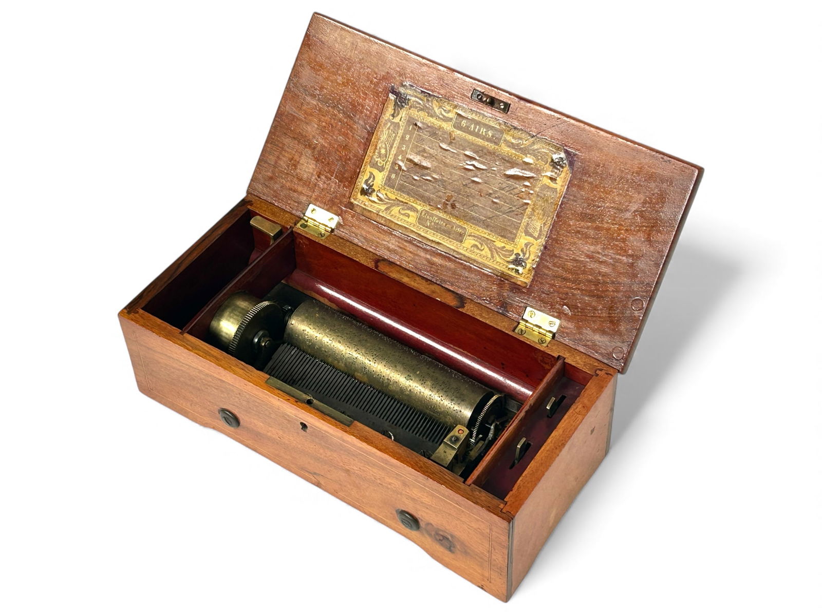 Antique Swiss Music Box, 6 Tunes.: The antique Swiss music box was imported by Paillard & Co. Importers. It has inlaid border designs on the top and front. It plays 6 tunes or airs, which are listed inside the lid in French. The music