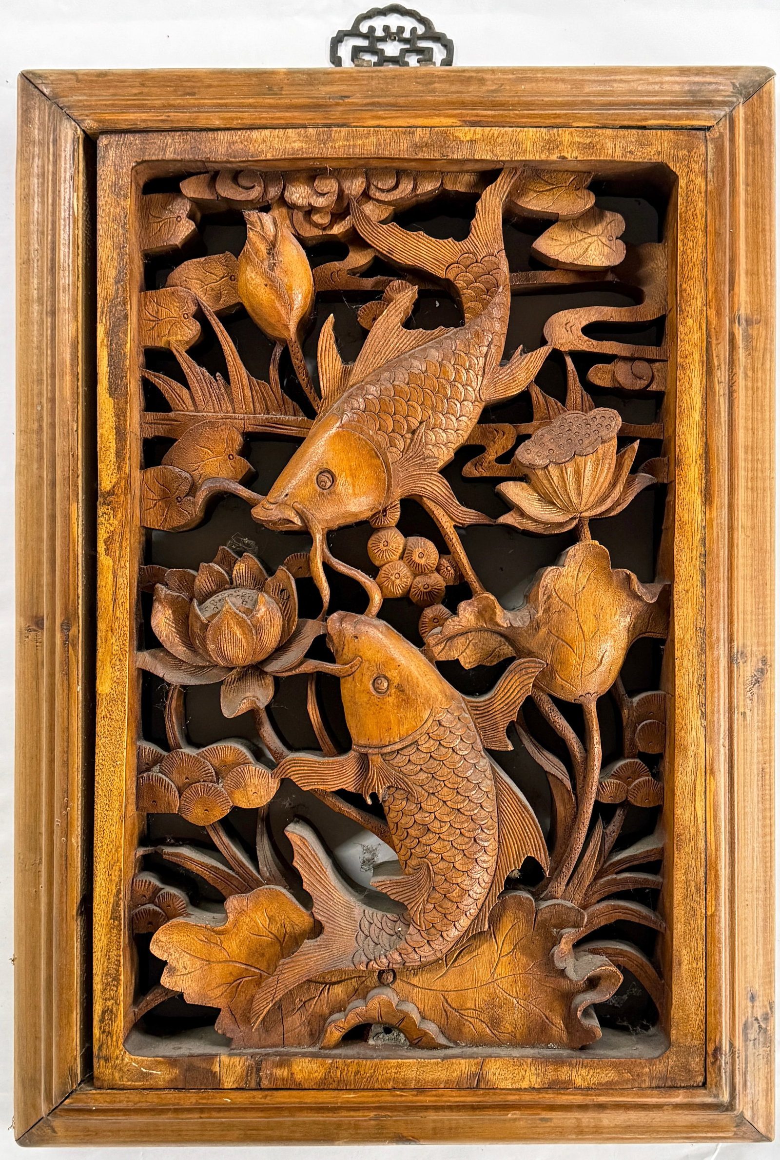 Chinese Hand Carved Wooden Panel w/ Koi Fish.: The panel or plaque has fish carvings and lotus flower carvings. The piece has a couple of minor cracks, but is in good overall condition. It measures 19" x 13 1/2", and is 2 3/8" thick. In-house ship