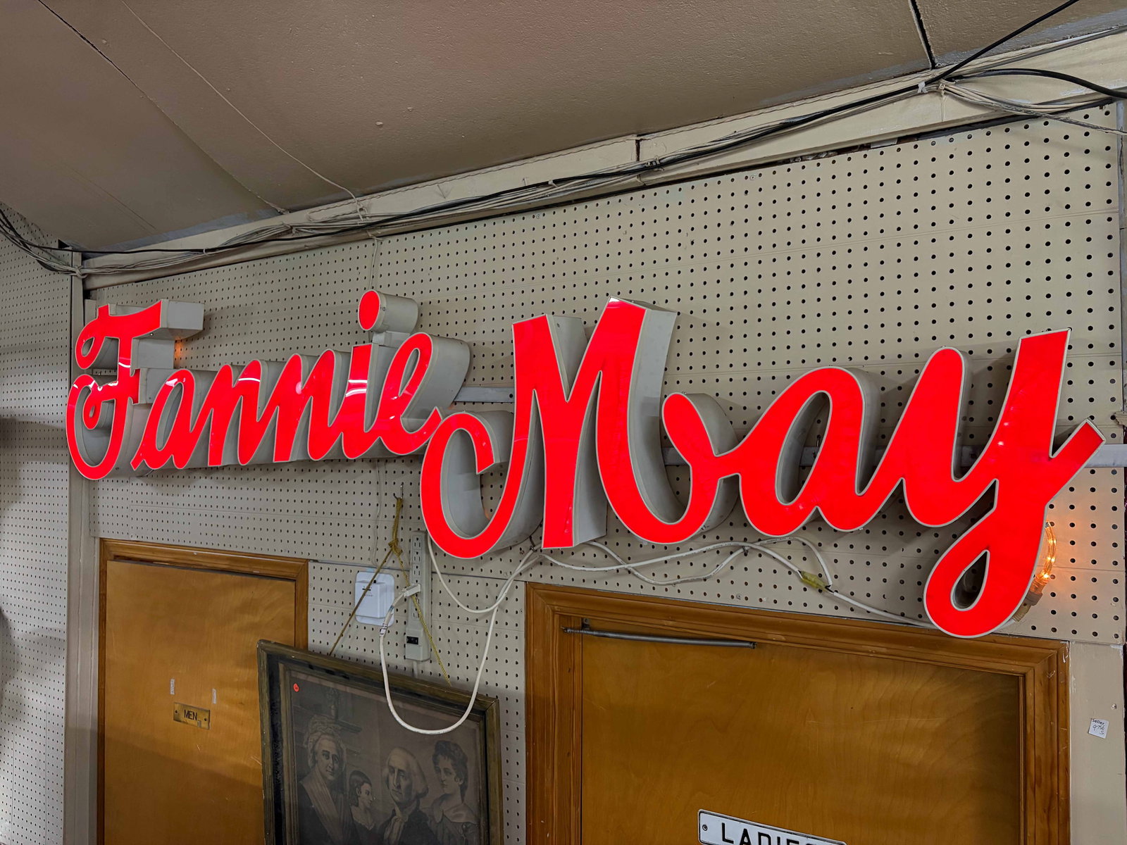 Large Light-Up Fannie May Chocolates Sign.: This plug-in sign looks to be in good cosmetic condition overall, and it lights up. It measures 100" wide, 32" from top to bottom, and 5 1/4" deep. Third-party freight shipping or personal pickup is r