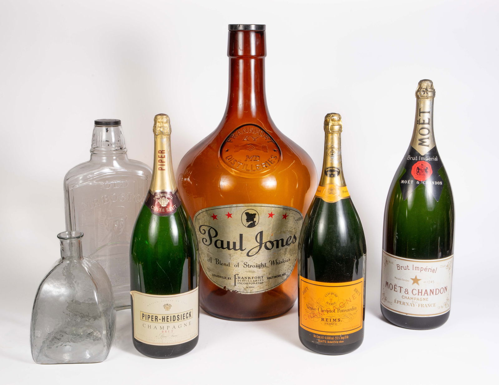 Lot of Oversized Wine & Whiskey Bottles.: They include Veuve Clicquot, Piper-Heidsieck, Moet Chandon, Paul Jones, Old Mr. Boston, and a blank bottle. There is some wear to the labels, but overall, the lot looks to be in good condition. The la