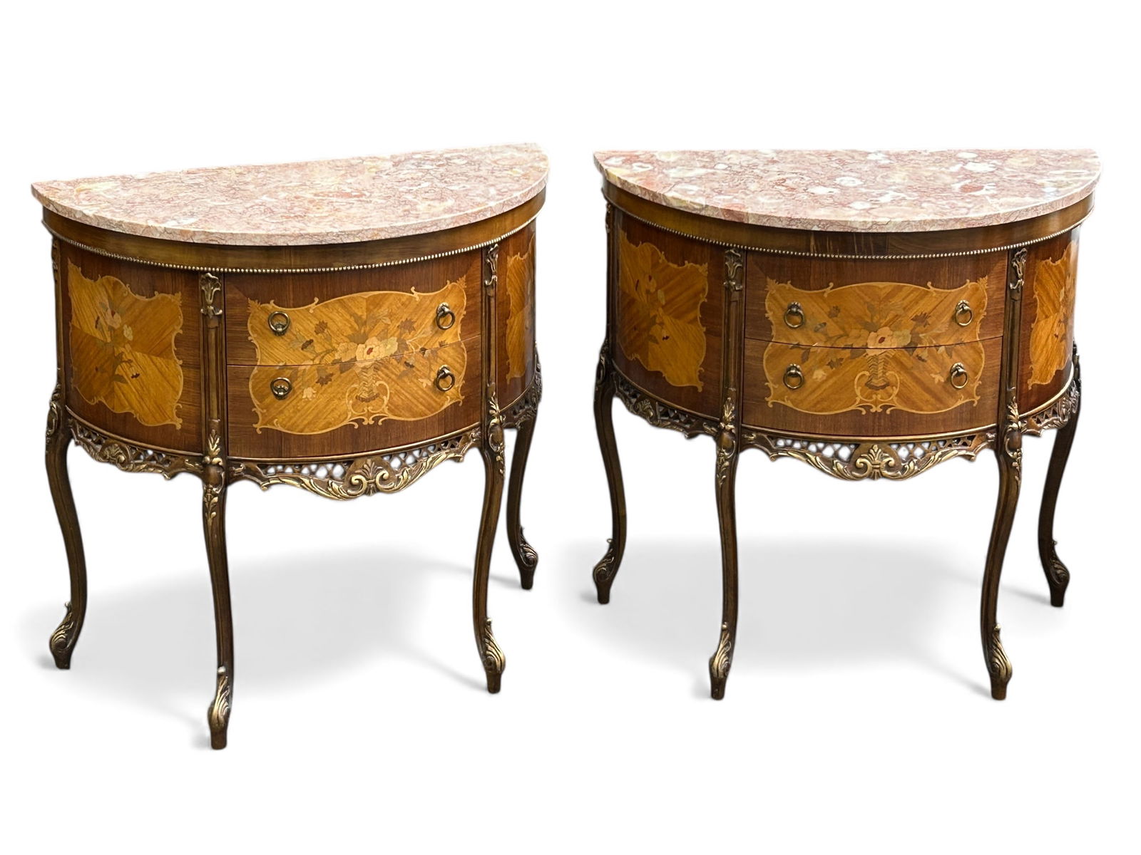 Pr. of Carved French Marble Top Demilune Commodes.: These Louis XV style pink marble top commodes each feature inlaid marquetry, beaded carvings, and two drawers with brass ring pulls. There are some scratches, but overall, the pieces are in good condi