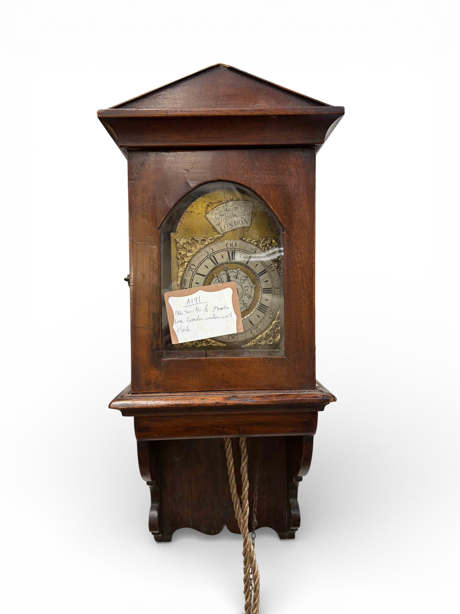 Bob Smith & Martin Lane Wag-on-the-Wall Clock.: This antique wooden clock was made in London. It measures 17 3/4" x 7" x 5 1/4". The ropes and weights are tangled, and there are scratches, stains, and chips on the item. It is untested. In-house shi