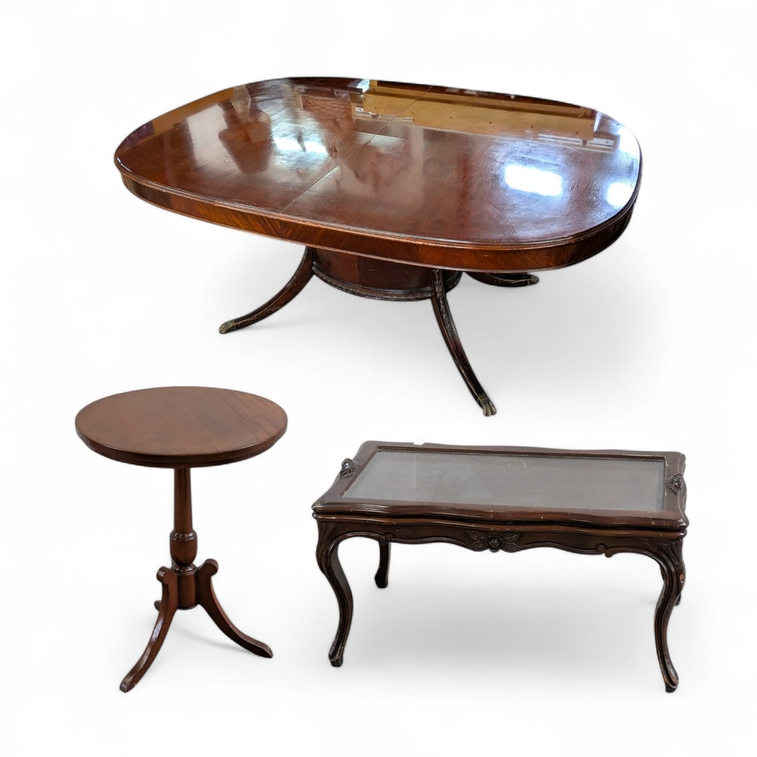 3 Carved Tables - Dining, Coffee Tray & Lamp Table: The lot contains 3 vintage wooden tables with carved decorations. First, there is a 6-person oval dining table with paw feet and flower carvings on the legs and cage. Next, there is a tray top coffee