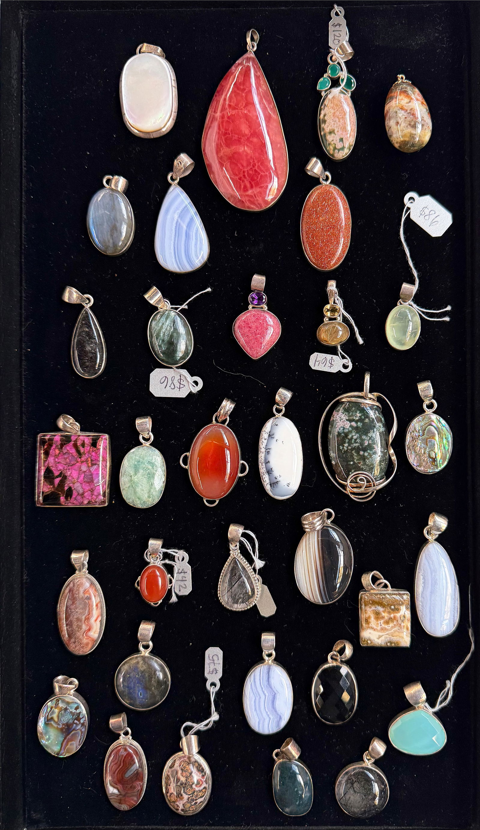 33 Sterling Silver & Gemstone Pendants.: The lot contains 33 sterling silver pendants with large gemstones. Some of the stones included are abalone, goldstone, jasper, mother of pearl, labradorite, amethyst, black tourmaline, carnelian, and