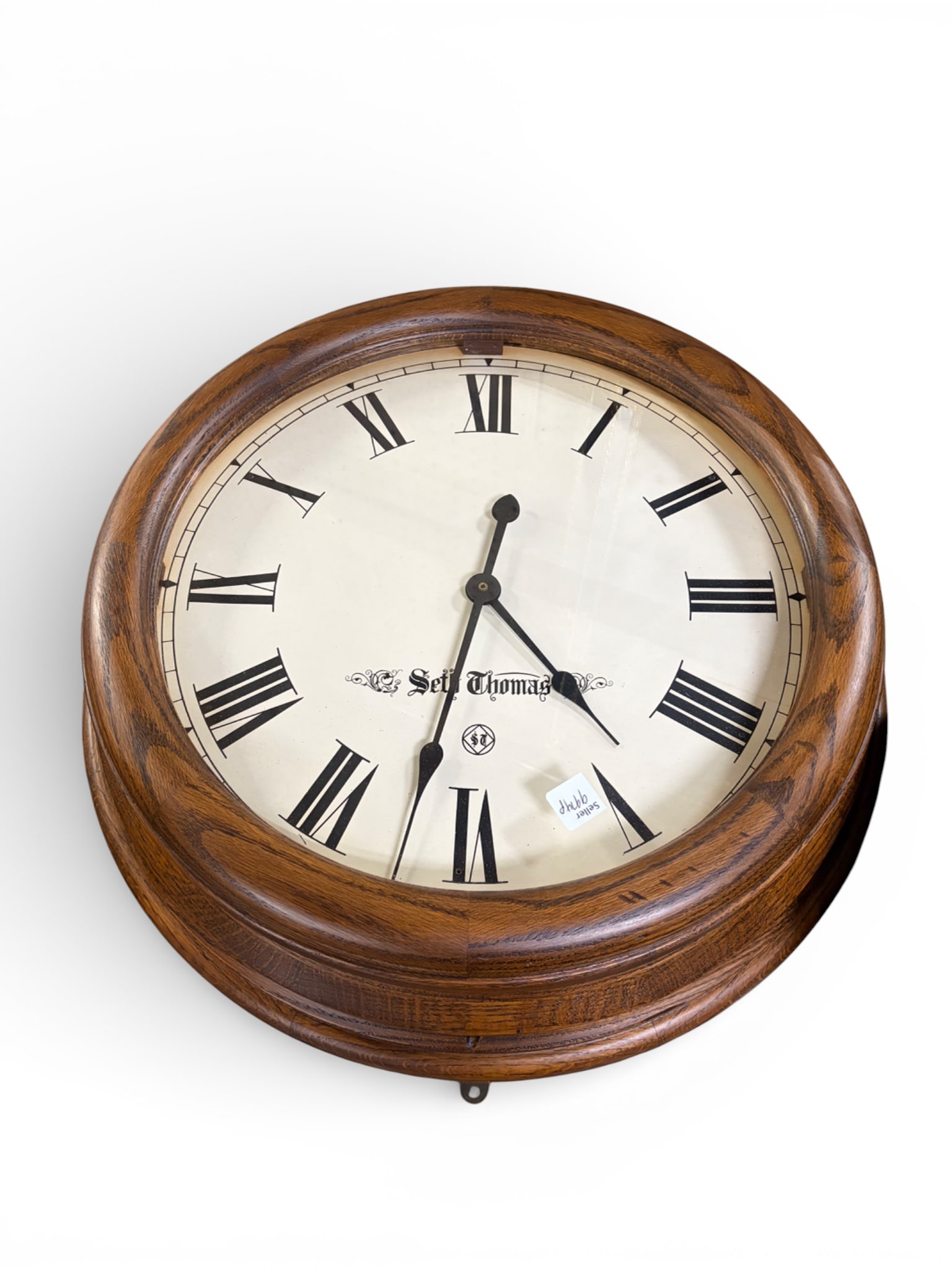 Seth Thomas Round Wall Clock.: The battery operated clock has a wooden bezel. The clock measures 5 3/4" x 23" x 23". There are a few stains on the piece. Otherwise, it is in overall good condition. In-house shipping is available. P