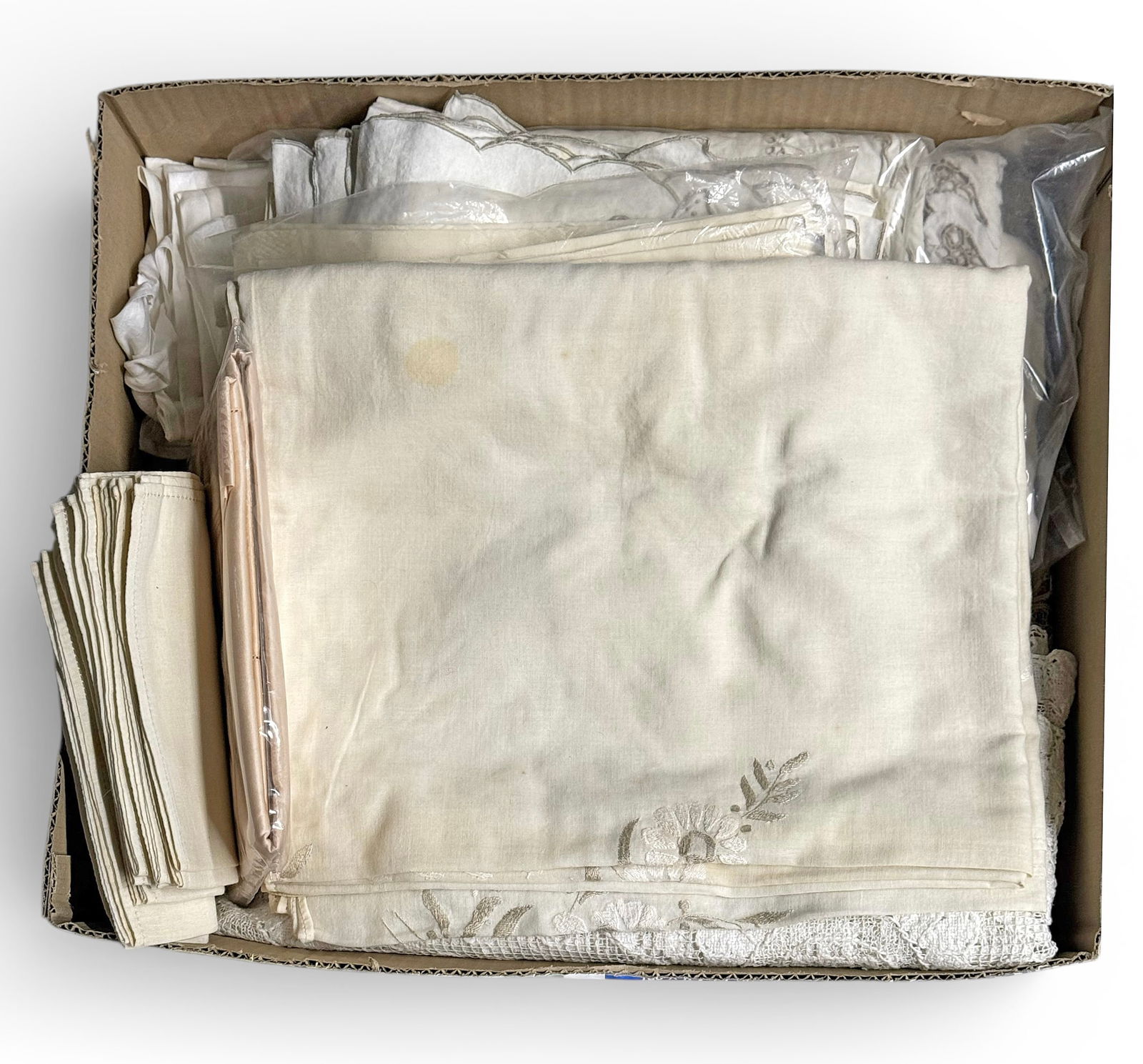 Box of Various Linens, inc. Tablecloths & Napkins.: The lot contains over 50 items. There are table cloths, table napkins, coasters, a pillow sham, and more. Most of the items are unbranded, but a couple are branded Frette and Anicini Italy. A couple o