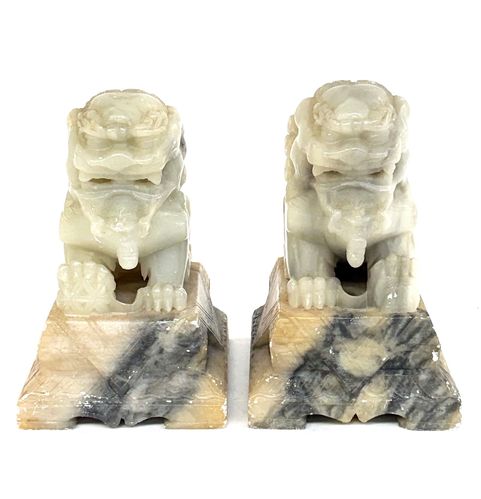Pr. 20th Cent. Chinese Soapstone Foo Dogs Bookends: The bases have quite a bit of white spots to the soapstone from wear. The foo dogs themselves are in good overall condition. Each foo dog measures 6" and 6 1/8" tall, with the bases measuring 3 3/4" x