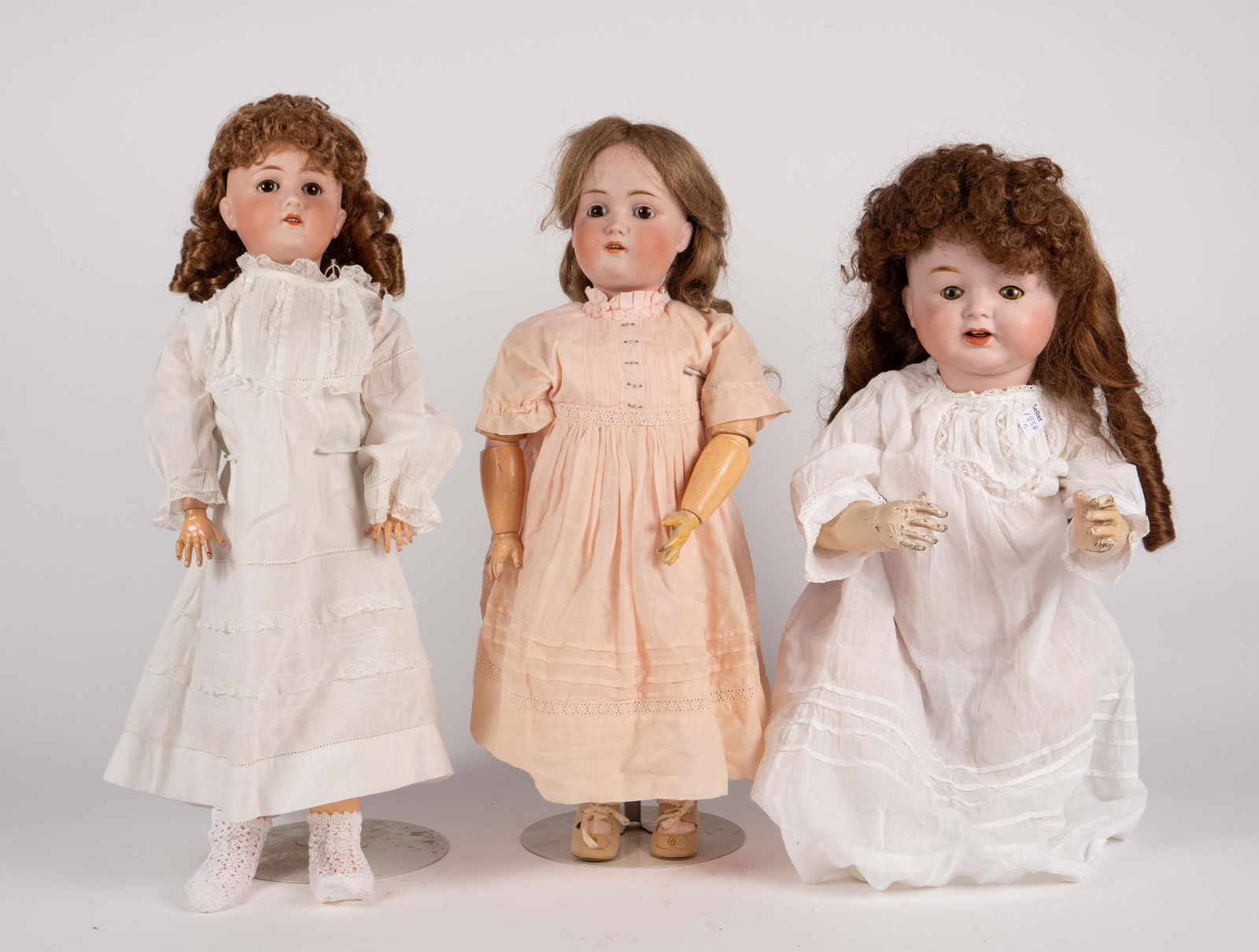 Lot of 3 Antique Bisque Dolls - Kestner, Reinhardt: The lot contains 3 antique bisque head dolls, one of them with sleepy eyes. The jointed bodies appear to be composition. The largest doll has sleepy eyes, and is marked Made in USA / ER / E Reinhardt