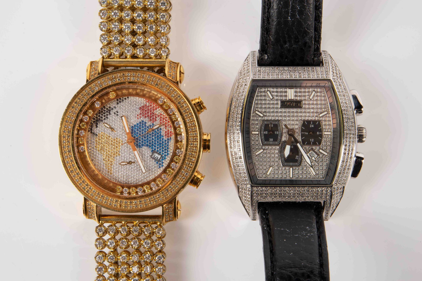 Lot of 2 JOJO Diamond Chronograph Watches.: The lot contains 2 diamond covered watches, JOJO by Joe Rodeo. They both have small round diamonds on the bezels and dials. The gold toned watch is the model Tyler, and features a world map design on