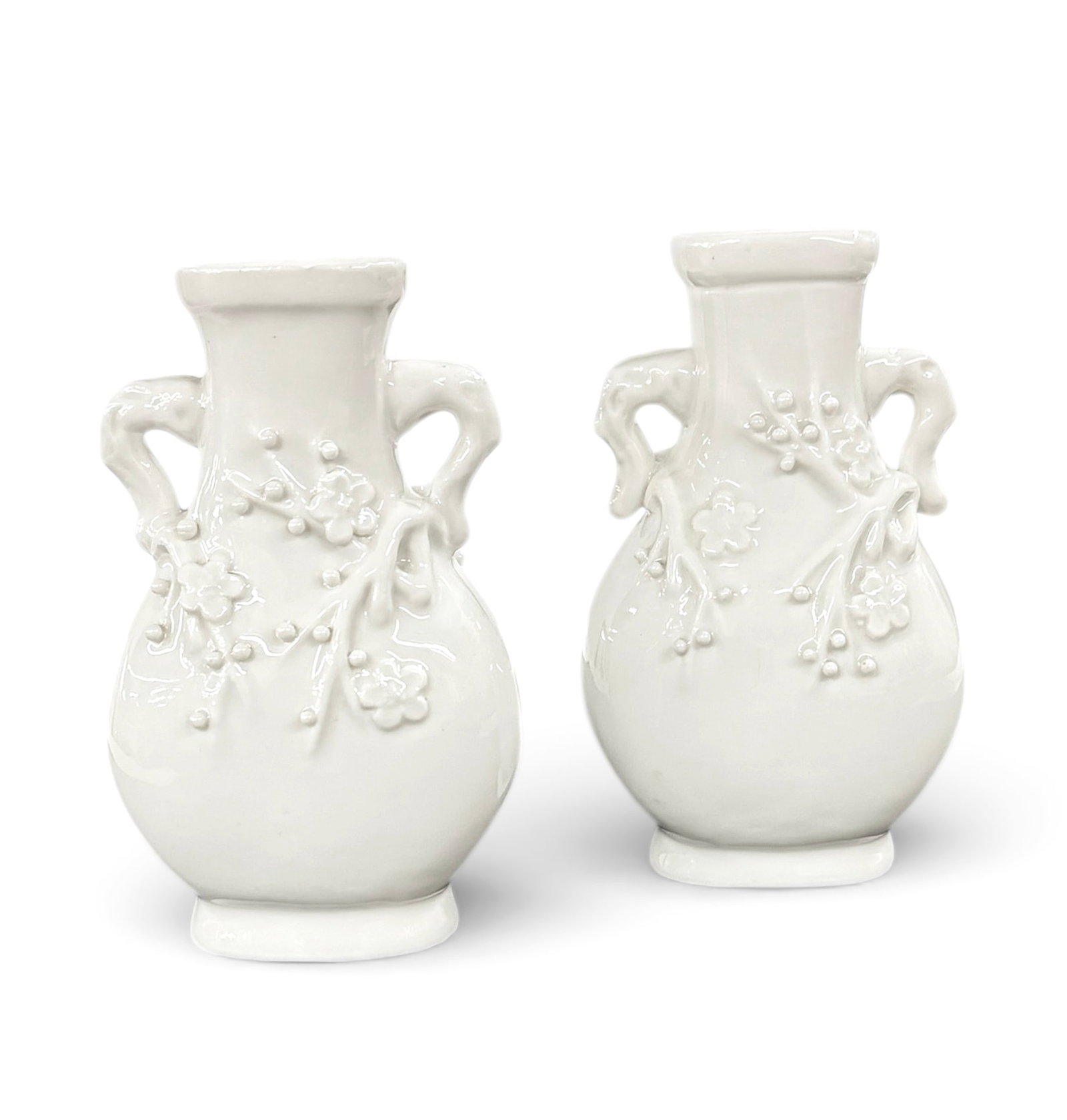 Pr of Small Chinese Blanc de Chine Porcelain Vases: The vases look to be in good overall condition, but one has a couple of tiny nicks or flea bites on its rim.. They are unsigned. Each measures 4 1/2" tall, 2 3/4" wide, and 2" deep. In-house shipping