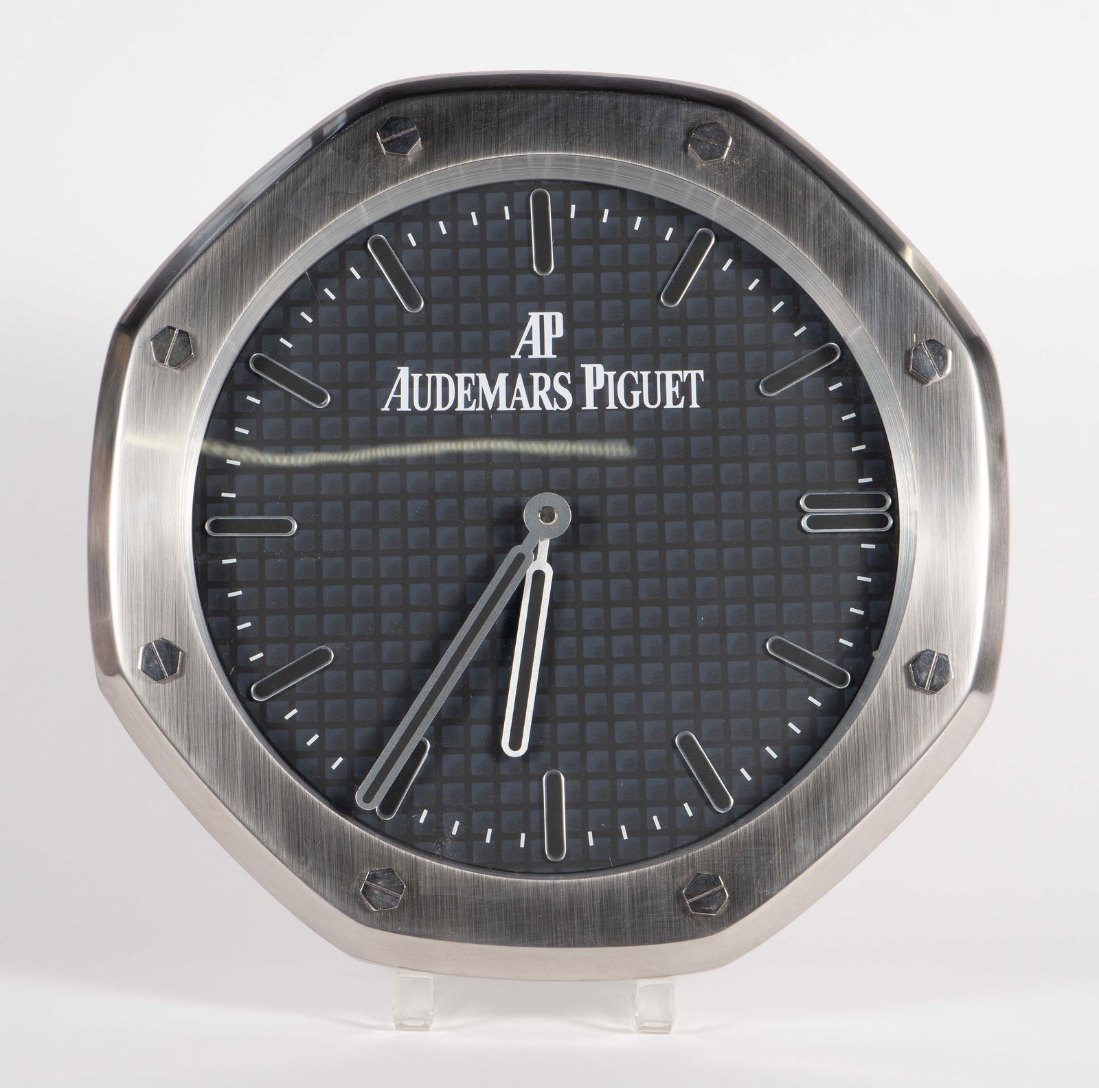 AP Audemars Piguet Octagonal Wall Clock.: This dealer clock works. It is a quartz battery operated wall clock, measuring 13 1/2" across, and 2 1/4" thick. Please note that there is a 2" crack visible on the glass surface. In-house shipping is