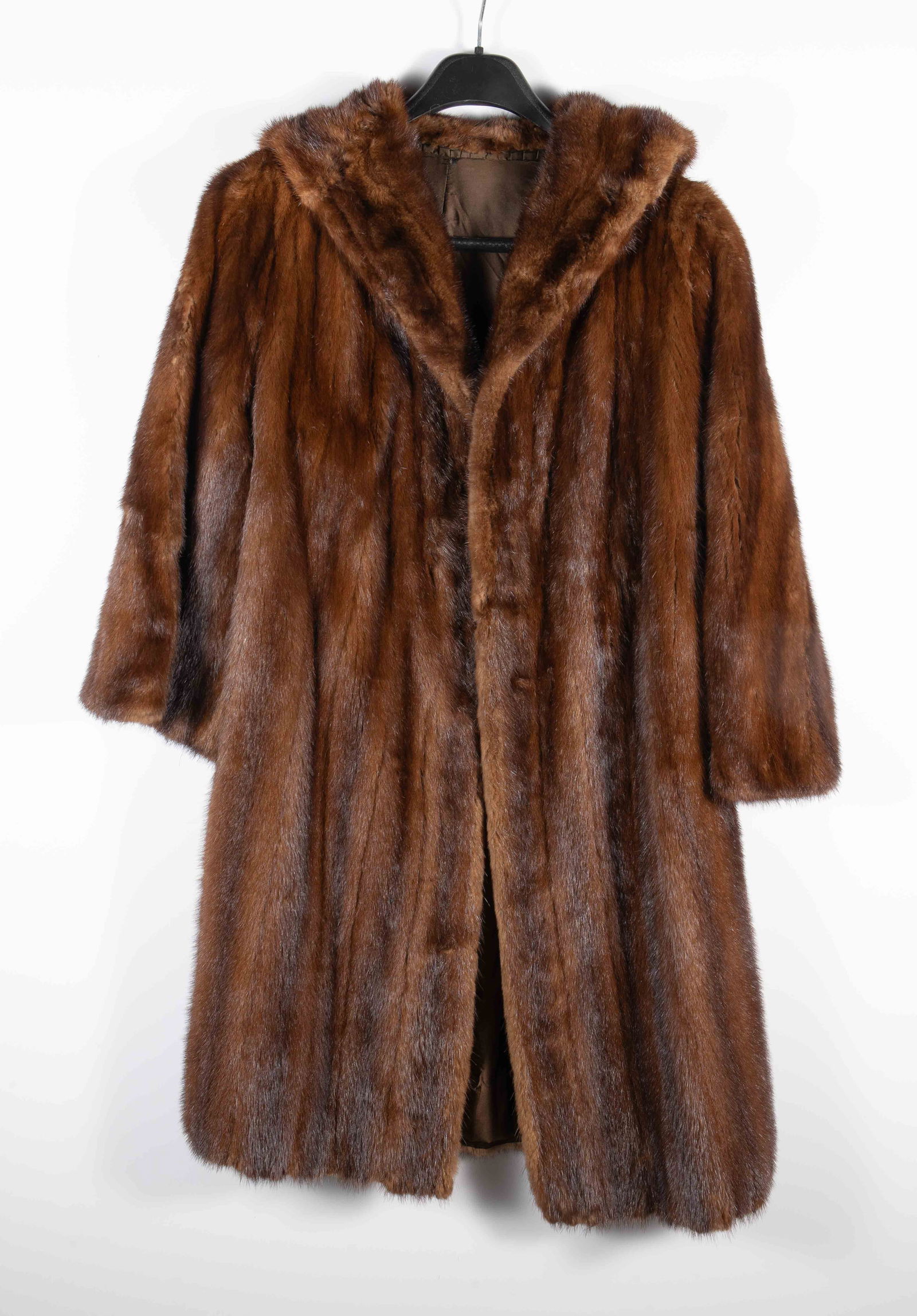 Ladies' Brown Mink Fur Coat.: The maker is unknown. There do not appear to be any hook or button closures, and there is a hole on the right sleeve. This coat may be best suited for a shorter woman. It measures 21" armpit to armpit