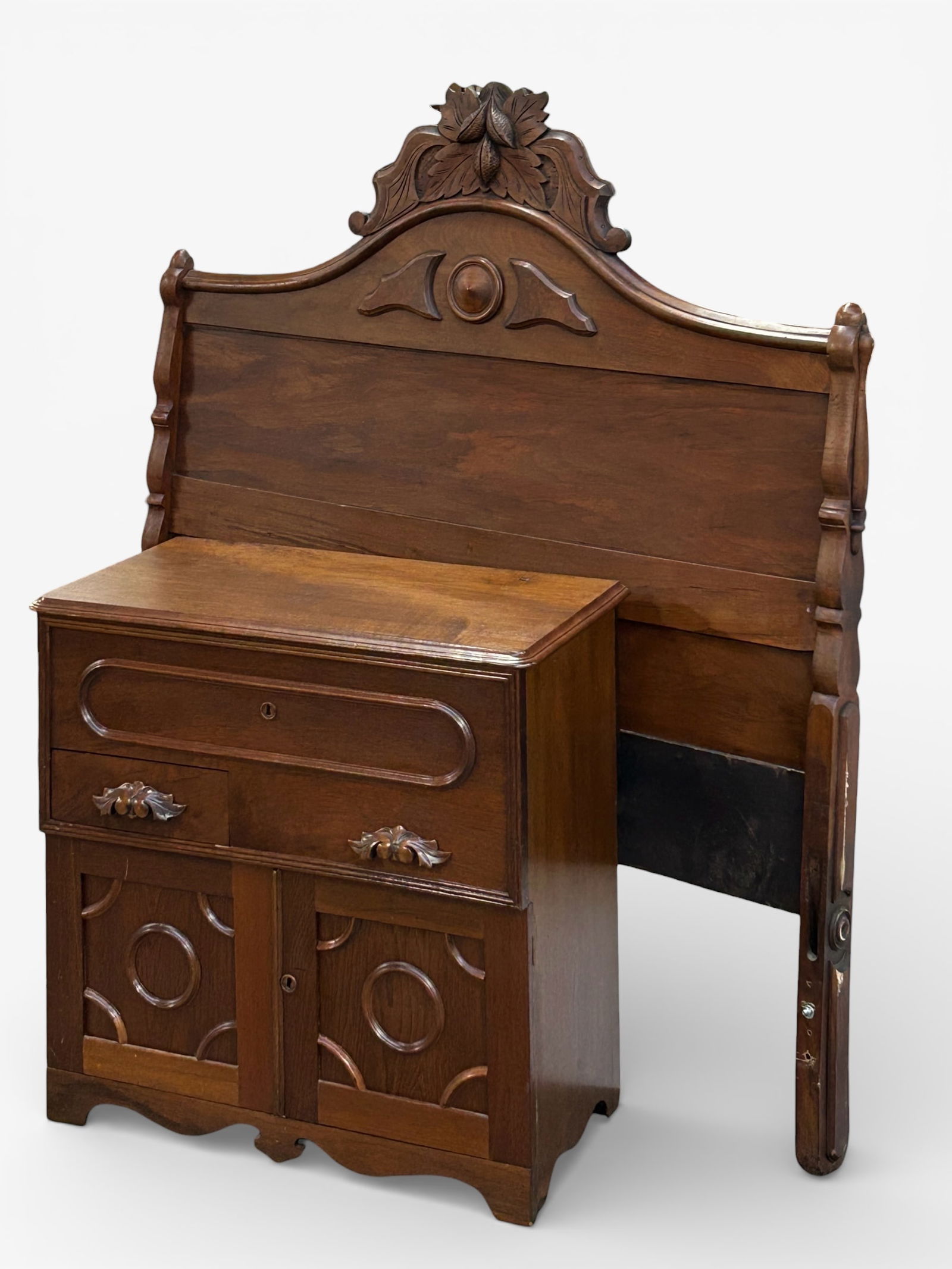 Victorian Carved Walnut Washstand & Headboard.: The washstand has a lift top with interior storage, a drawer, and two doors with a storage section. It has fruit pulls. Also included is a headboard with a crest of leaves and fruit. There are some sc