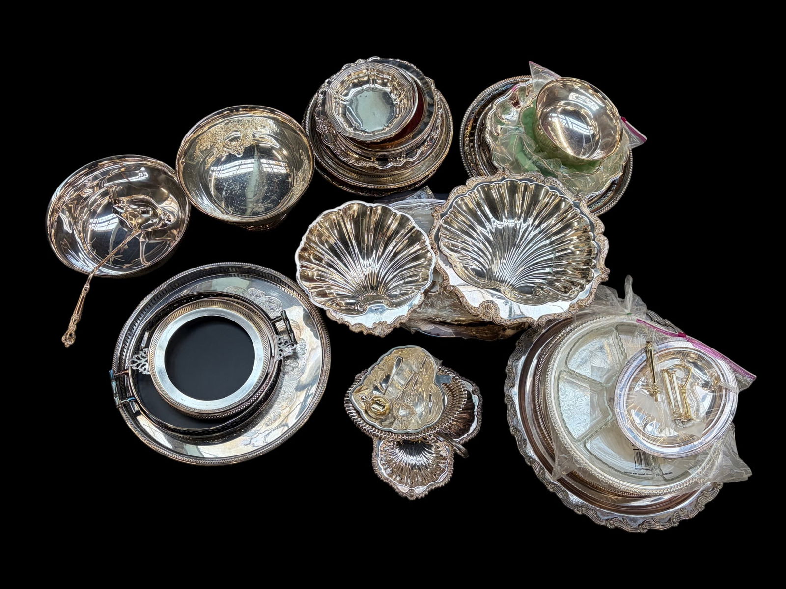 Lot of Mostly Silverplate Trays & More - Orleans.: The lot contains nearly 50 items. There are trays, serving bowls, bread baskets, a double ended ladle, casserole holders, seashell trays, a footed bowl, and more. Some of the marks or brands observed