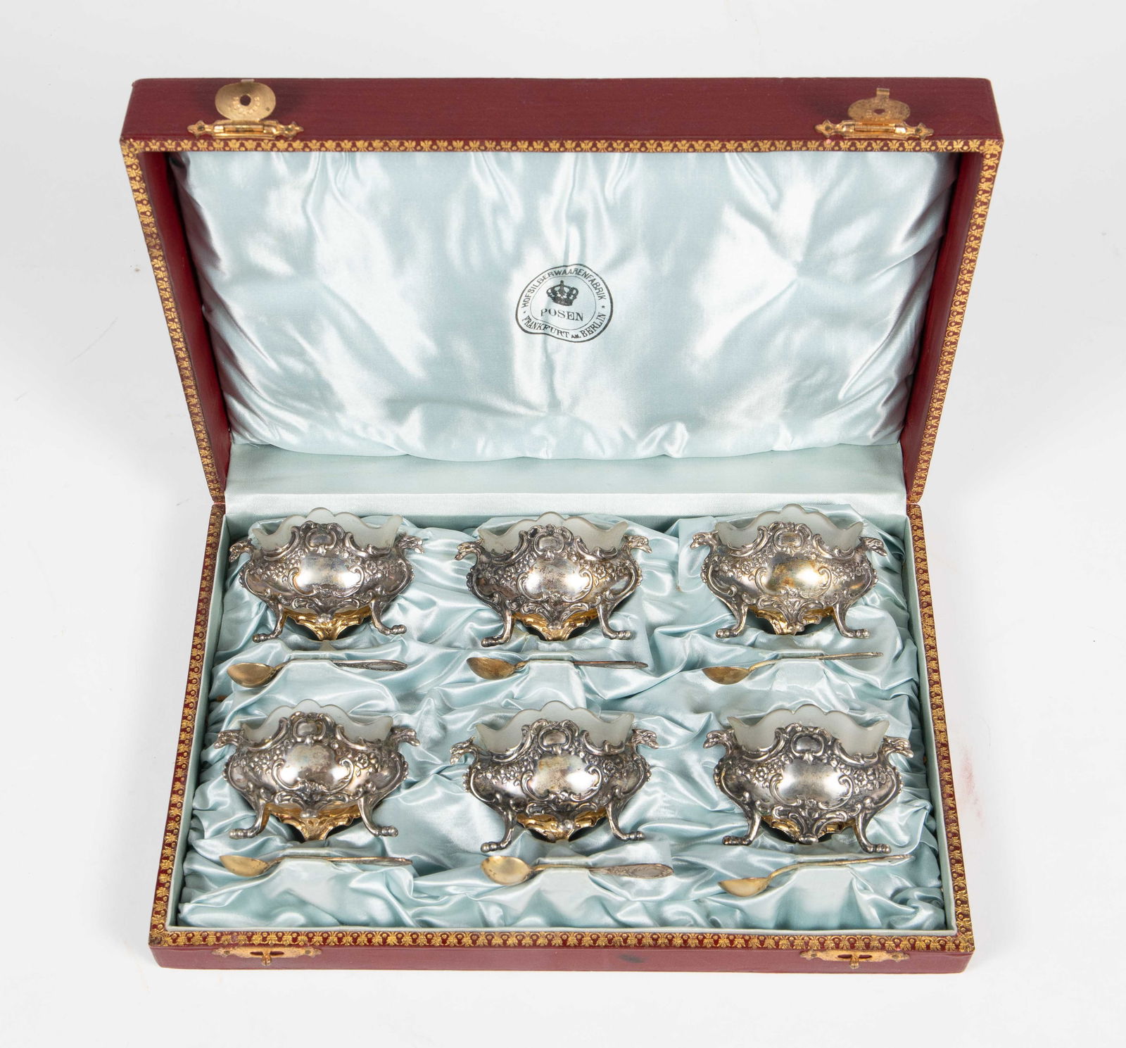 Set of 6 Silver Salt Cellars & Spoons w/ Case.: This German set includes 6 ornate silver salt cellars with glass inserts, and 6 matching tiny spoons. The cellars each have two bird heads and bird feet. With the glass inserts inside, each cellar